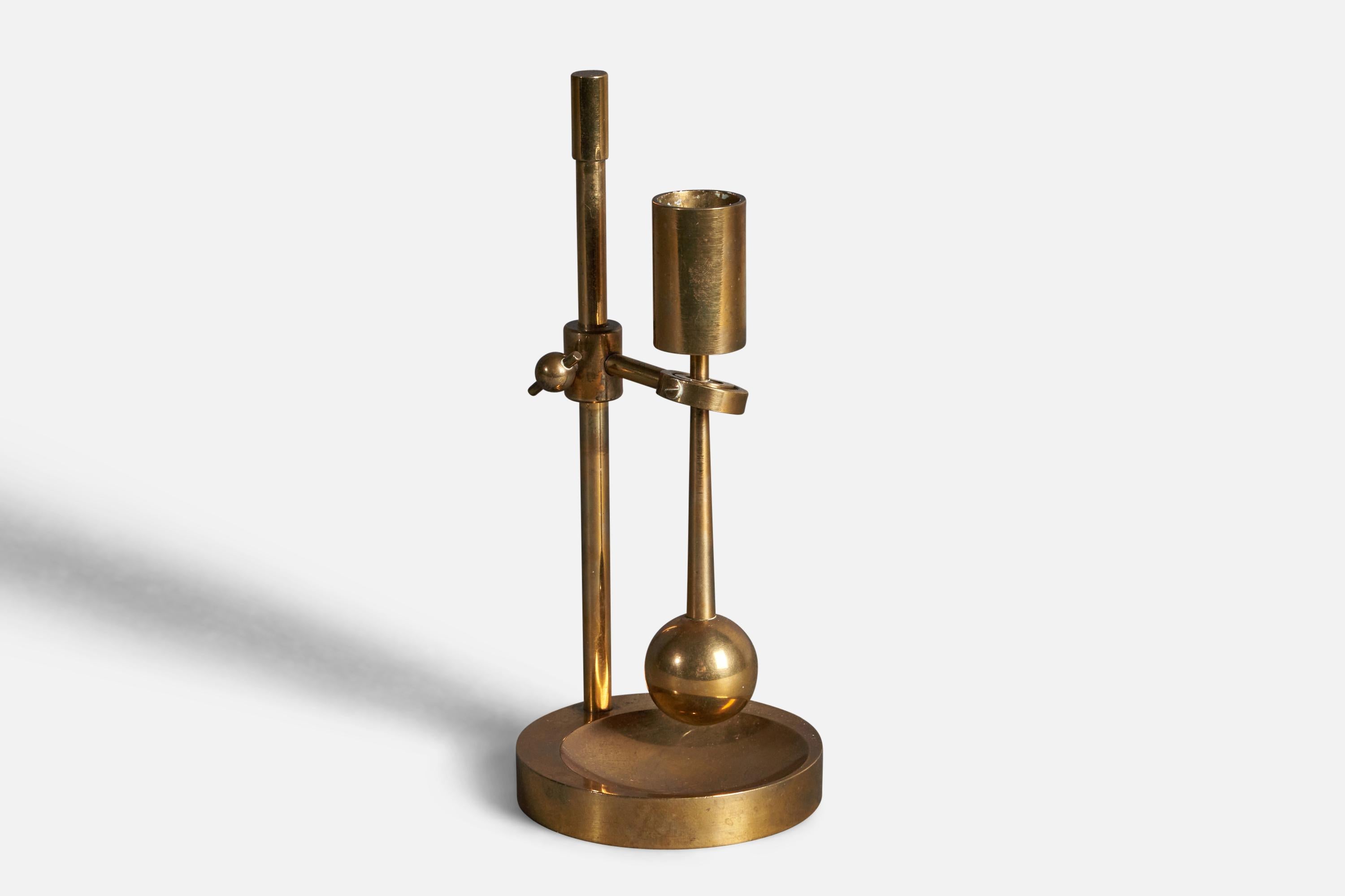 An adjustable brass candlestick designed and produced by Ilse D. Ammonsen, Denmark, 1950s. 

Counter weight function protects from candle grease spill when moved.