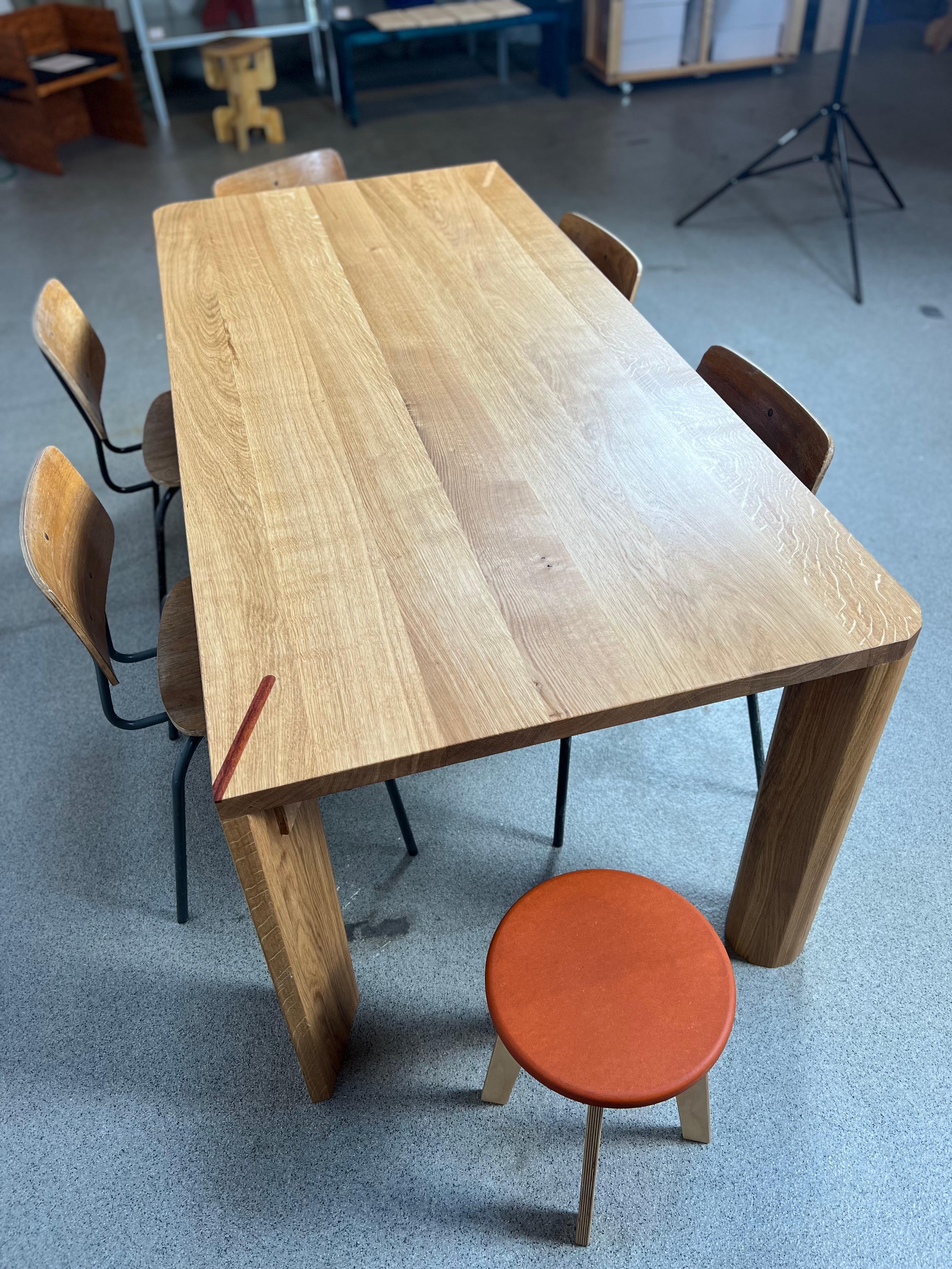 This handcrafted dining table is a modern design masterpiece, combining simplicity with architectural elegance. Its clean, rectangular form is complemented by rounded leg profiles, offering a sleek yet warm presence that makes it perfect for any