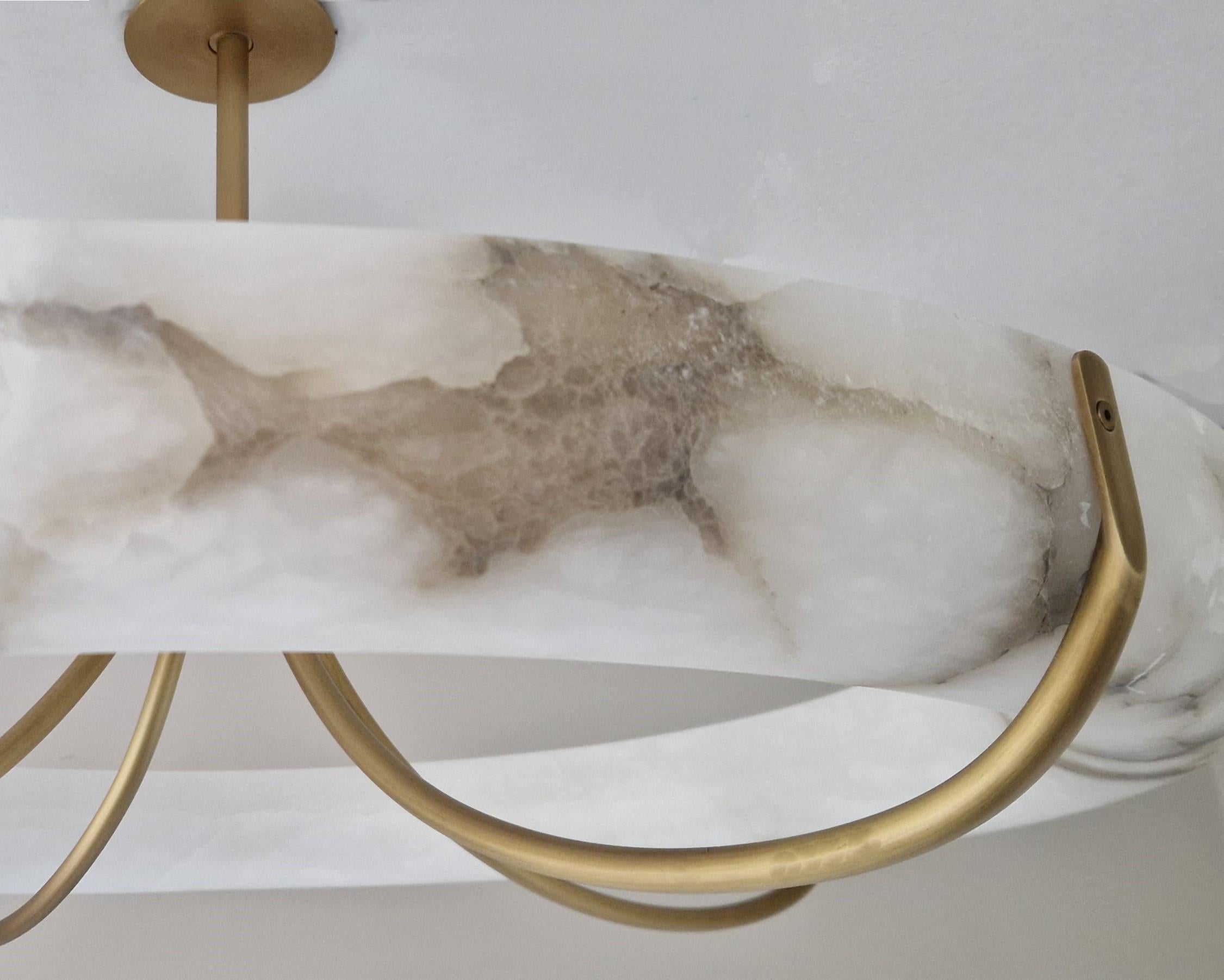 Alabaster ring pendant with antique brass metalwork and integrated LED light source. Acrylic diffuser to top of ring to diffuse the light source. 

Dimensions: 
Overall Diameter: 900mm 
Ceiling Plate Diameter: 120mm 
Overall Height: 480mm 

Made to