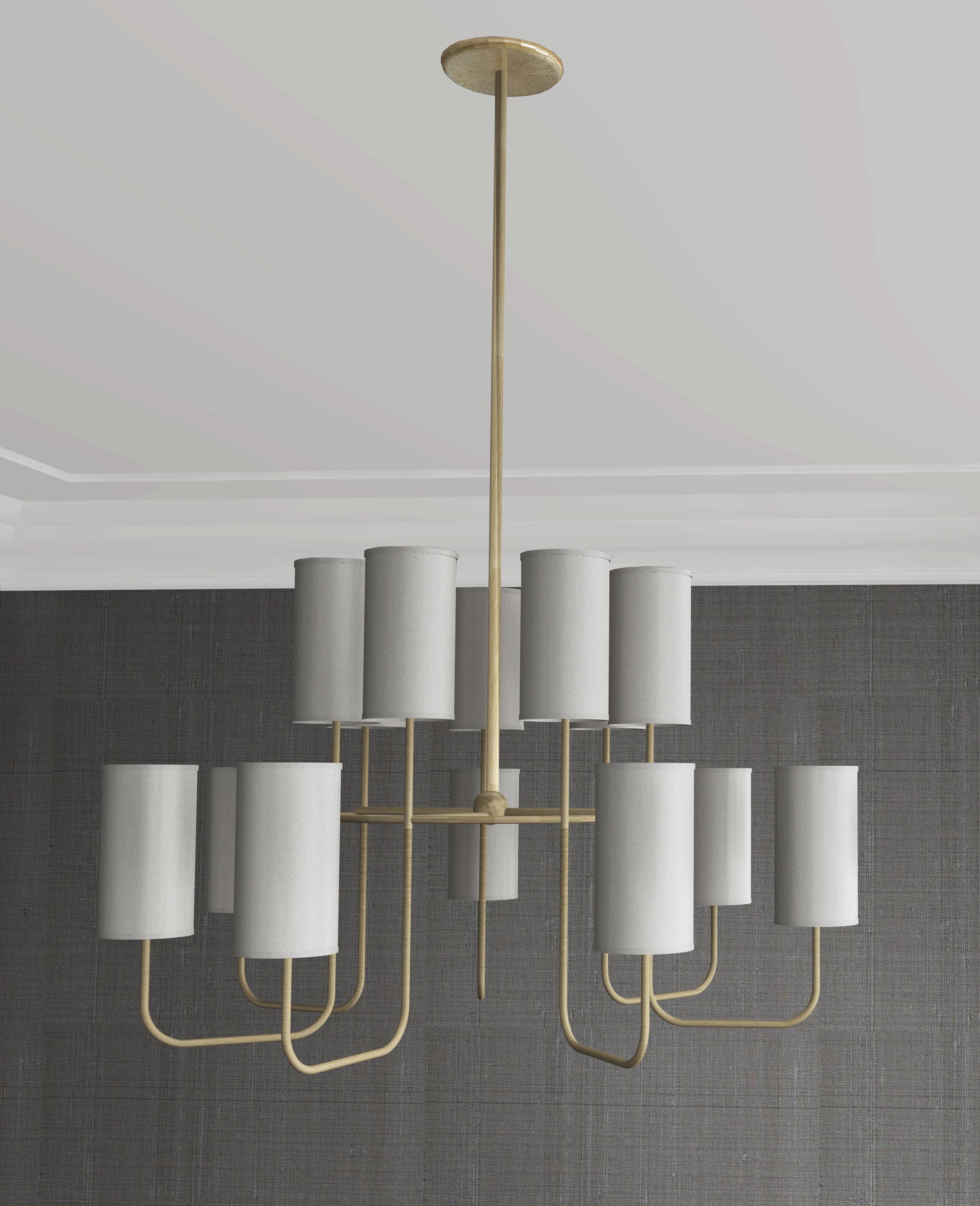 This chandelier is a modern take on tradition. Beautifully crafted with elegant materials including brushed brass and sateen shades. The tall, timeless shades add a modern touch to the classic motif base, giving a familiar, yet forward looking