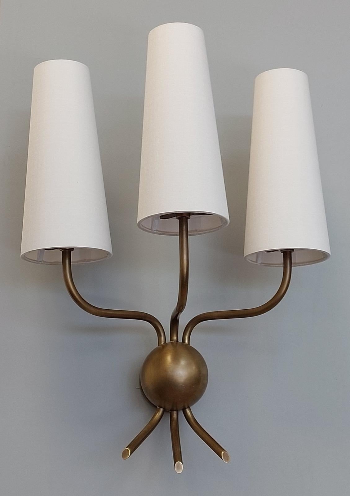 Bespoke three-light sconce, finished in a stunning waxed bronze, this wall sconce is expertly crafted by some of the finest artisans of Europe.
Overall height: 475mm
Shade Height: 220mm
Overall projection: 160mm
Overall Width: 360mm
3 x E14 candle