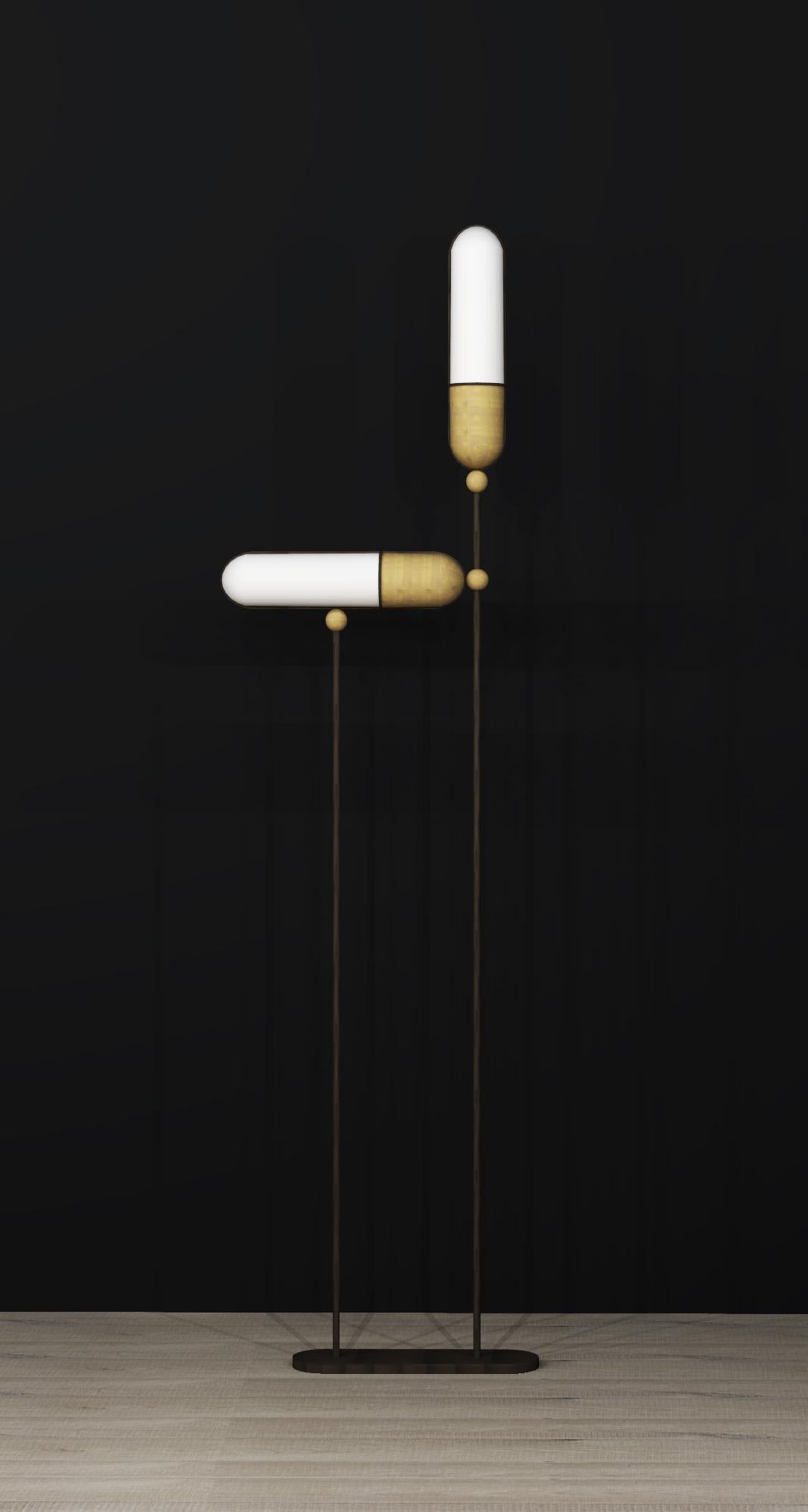 Inspiration for this floor lamp is taken from “The Century Building” Lobby in New York. This collection is crafted from vertical rounded linear bronze frame with glass and brass shade insert to either sides. Sleek and elegant antique bronze and