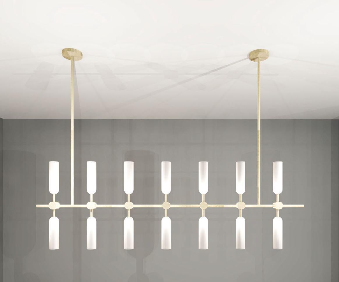 Elegantly simple, this chandelier pairs light brass with frosted glass to create a delicate, subdued design.

Dimensions: 
Shade Height: 170mm 
Shade Dia: 45mm 
Overall Width: 1280mm 
Overall Drop: 820mm 

Made to order. Variations to dimensions and