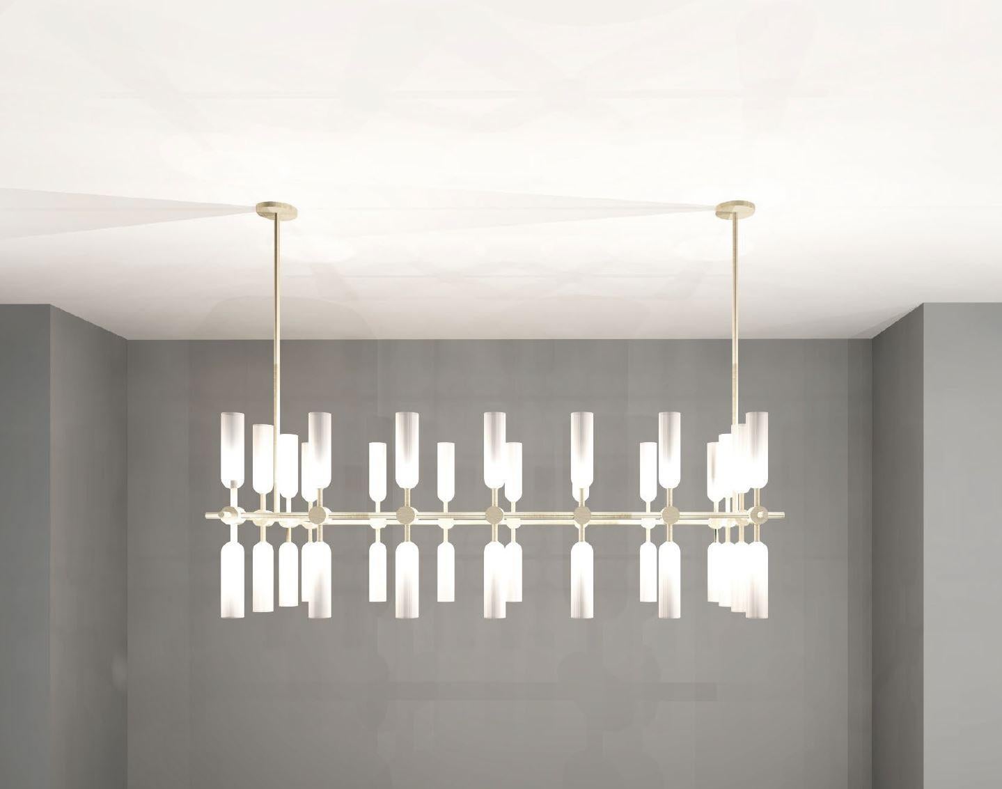 Elegantly simple, this chandelier pairs light brass with frosted glass to create a delicate, subdued design.

Shade Height: 170mm 
Shade Dia: 45mm 
Overall Width: 1280mm 
Overall Depth: 680mm 
Overall Height: 820mm 

 Made to order to buyer's