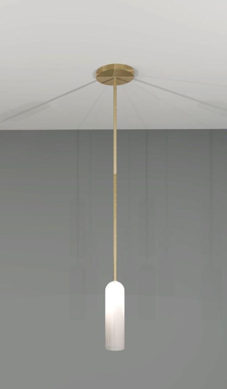 Elegantly simple, this pendant pairs light brass with frosted glass to create a delicate, subdued design.

Shade Dia: 45mm 
Shade Height: 170mm 
Overall Drop: 820mm 

Made to order to buyer's specification. Variations to dimensions and finishes can