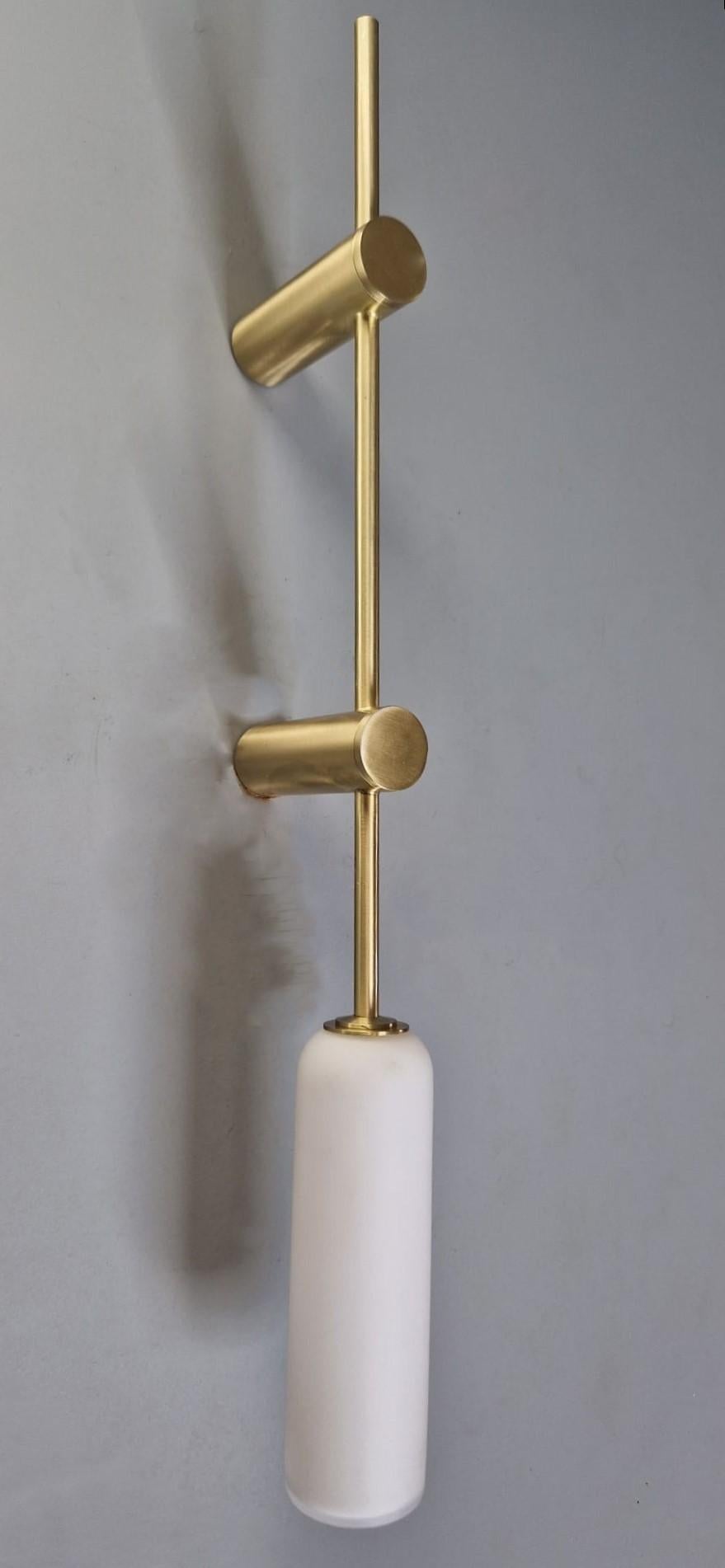 Elegantly simple, this wall light pairs light brass with frosted glass to create a delicate, subdued design.

Overall height: 550mm
Projection: 100mm
Shade Height: 170mm
Shade Diameter: 45mm

Made to order to buyer's specification. Variations to