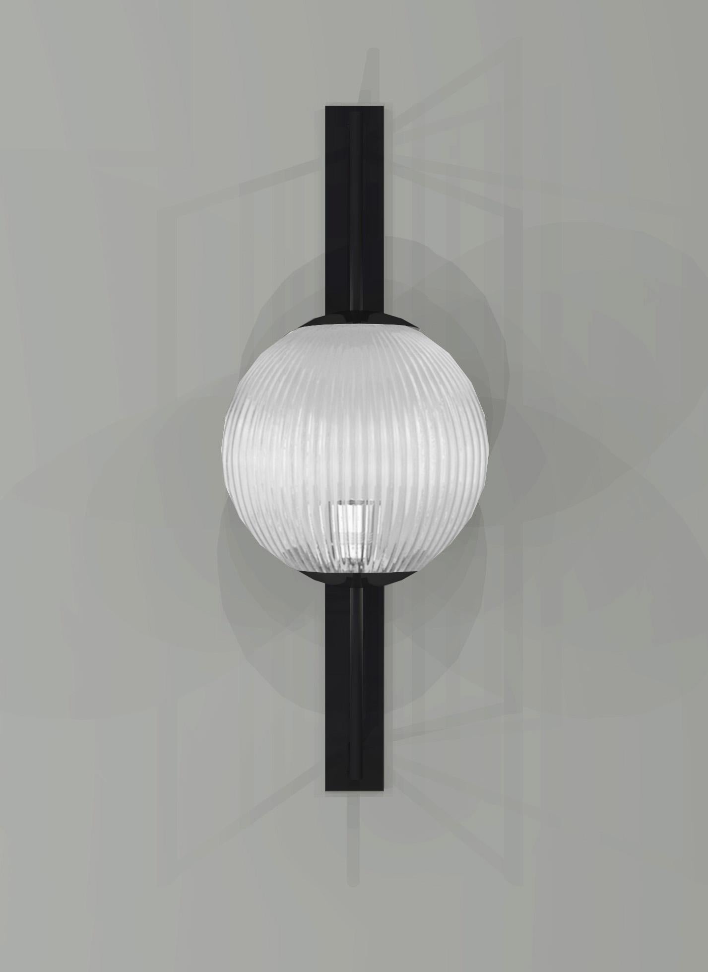 The inspiration of shape for this wall light is taken from concrete pattern design, lines and circles embossed onto the concrete panel. The concept for materials is taken from the Industrial design, metal and glass, linear metal frame with