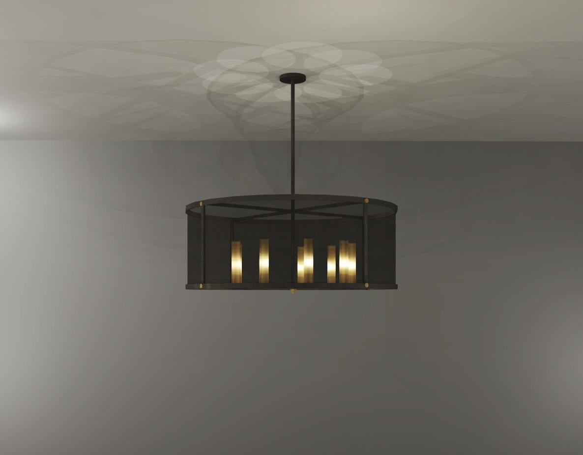 This chandelier is made from two types of metal: antique bronze and antique brass. The light source is concealed with an antique brass mesh, while outer shade with antique bronze mesh. The main idea for this design was continuously layering of