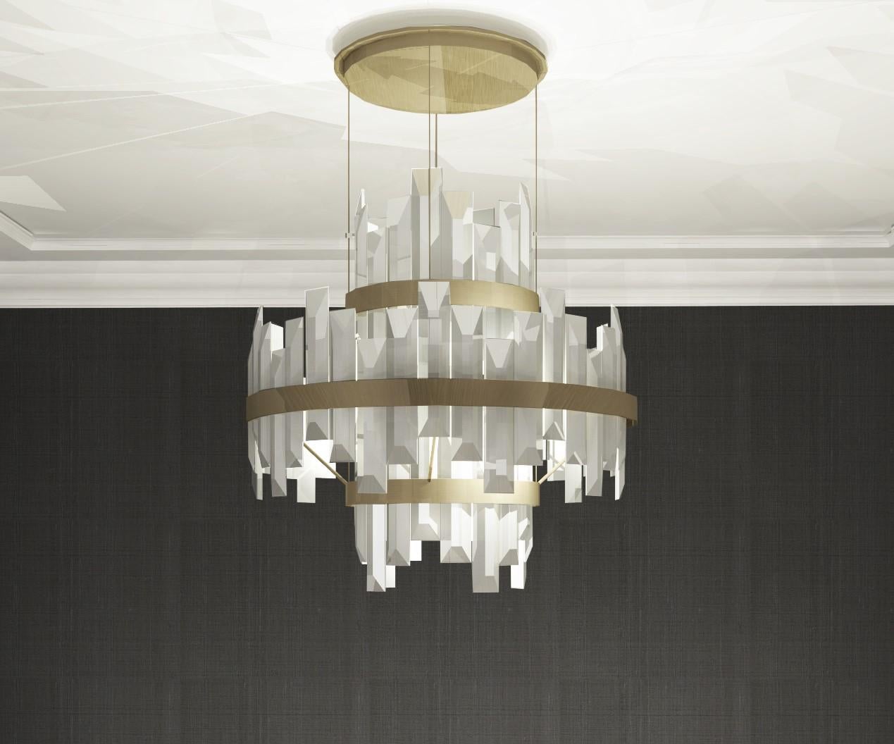 This chandelier uses a mix of bold materials, brushed brass band and over-sized crystal elements, to give impact whilst remaining clean and classic. The designs cool, clean, beveled-edge crystals give a beautiful reflection and transparency, whilst