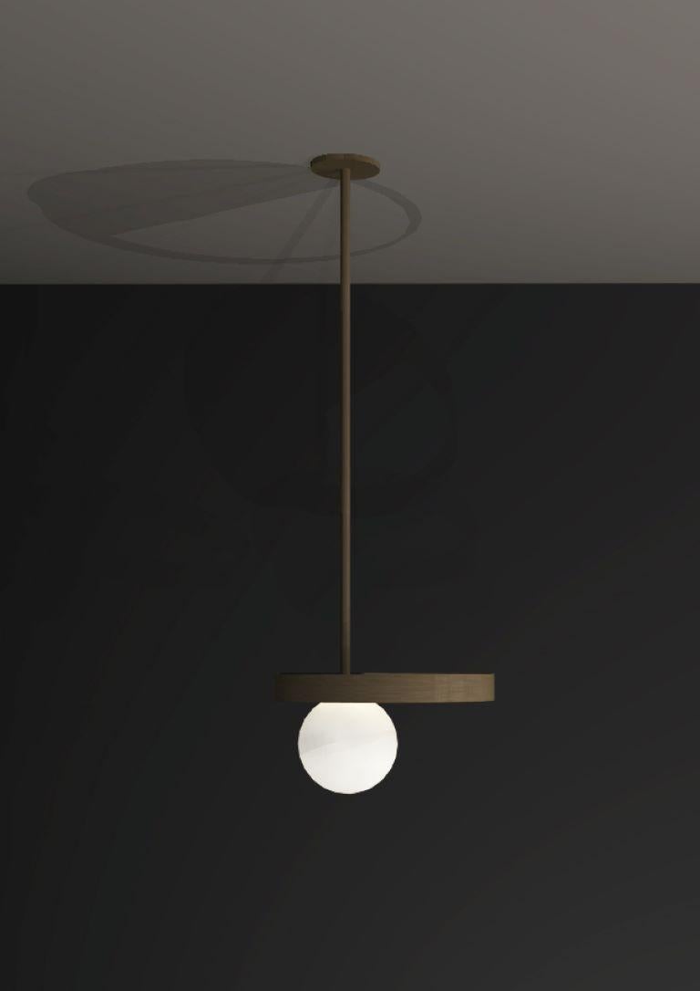This collection piece is a play of geometric shapes inspired by Constructivist El Lissitzky’s “beat the whites with the red wedge” work. The ceiling flush light combines frosted glass globes with geometric shapes made from brushed black metal and
