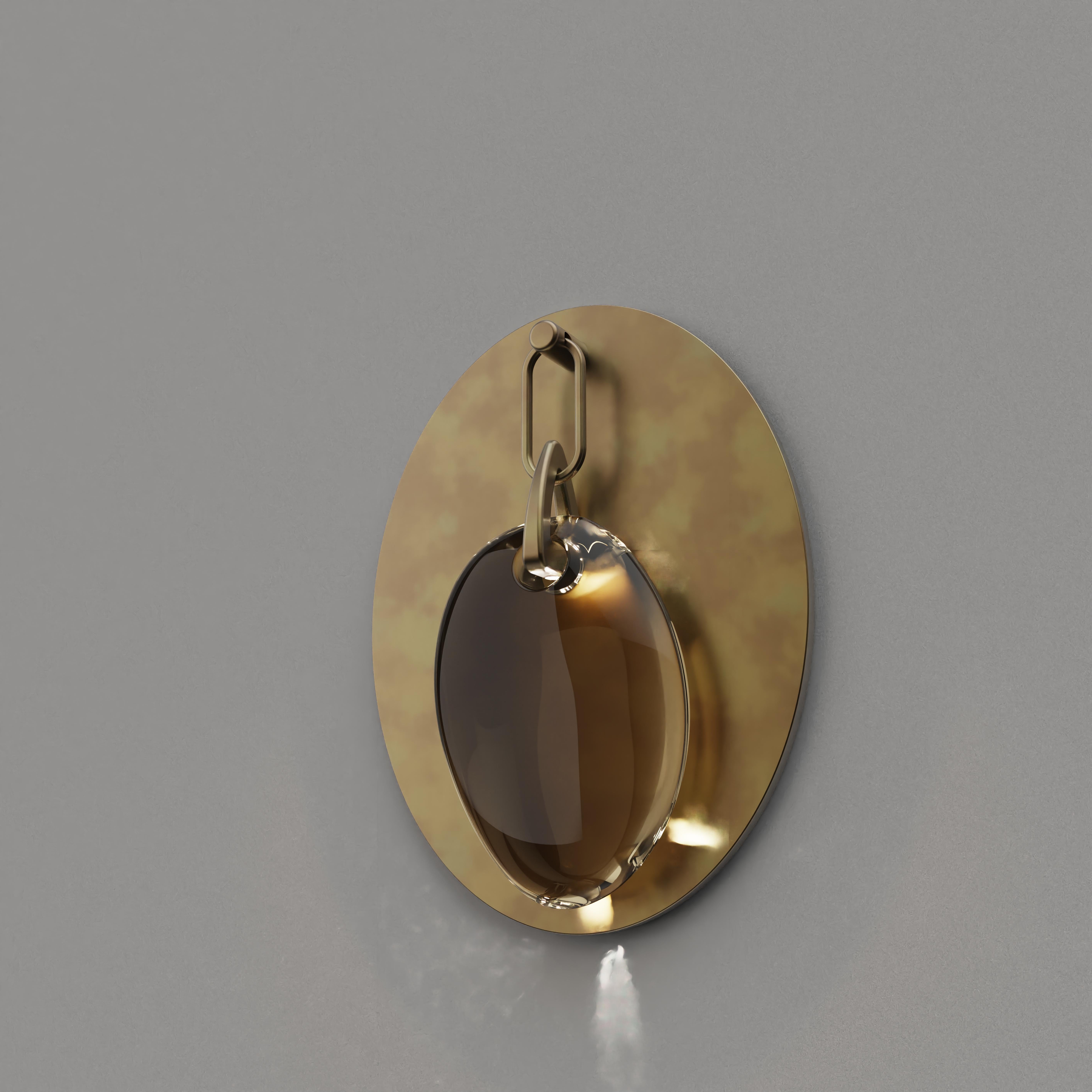 Crafted from hand blown glass with an array of colour/finish options, this stunning wall light piece is a perfect match to the feature pendants in this collection.

Finish: antique brass and coloured glass.
Light Source: Integrated LED
Overall