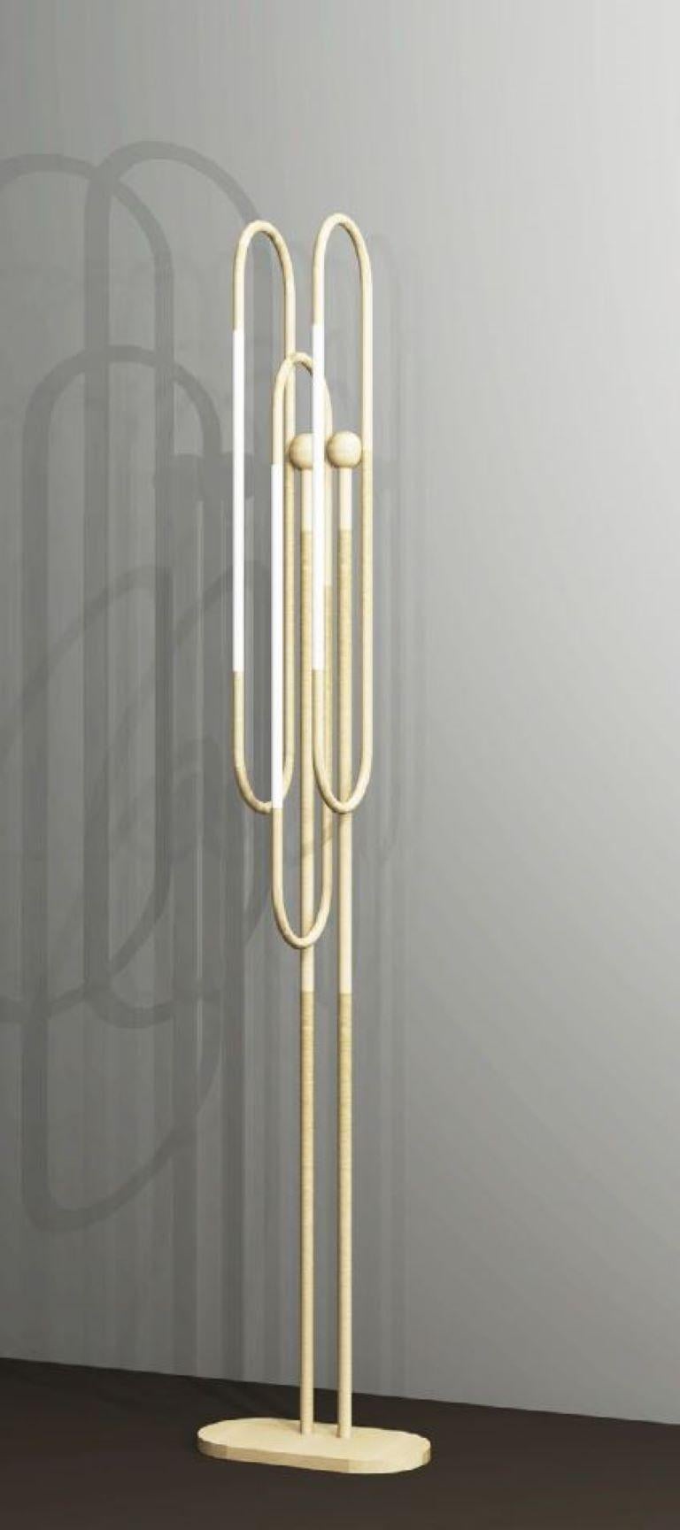 This floor lamp is based on infinite loops of brass, coiling continuously to create a free and fluid structure, with subtly integrated lighting elements.
Finishes: brushed brass and opal glass

Height: 1500mm
Width: 120mm
Depth: 100mm
Rod Dia: