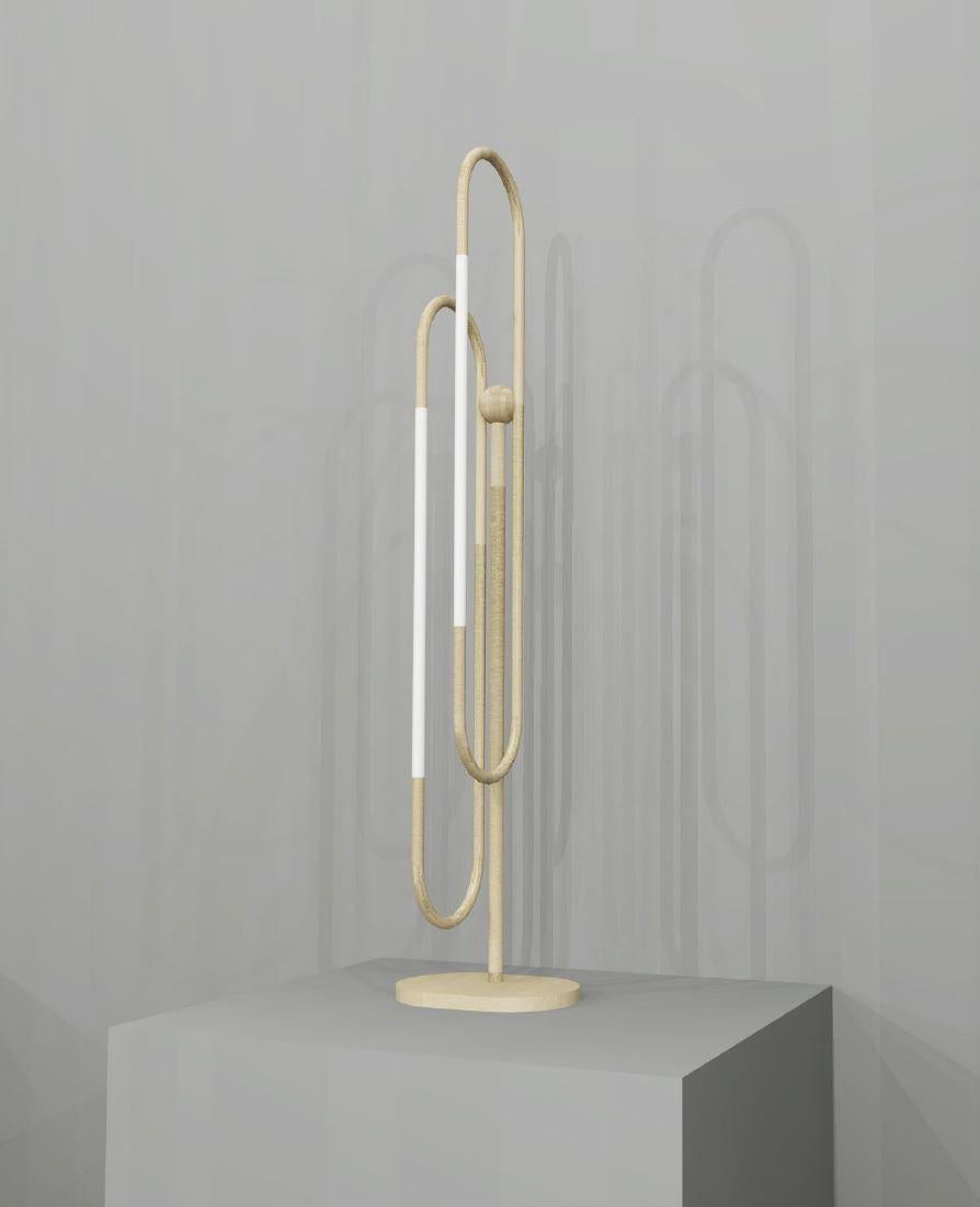 This table lamp is based on infinite loops of brass, coiling continuously to create a free and fluid structure, with subtly integrated lighting elements.
Finishes: brushed brass and opal glass

Height: 650mm
Width: 50mm
Depth: 100mm
Rod Dia:
