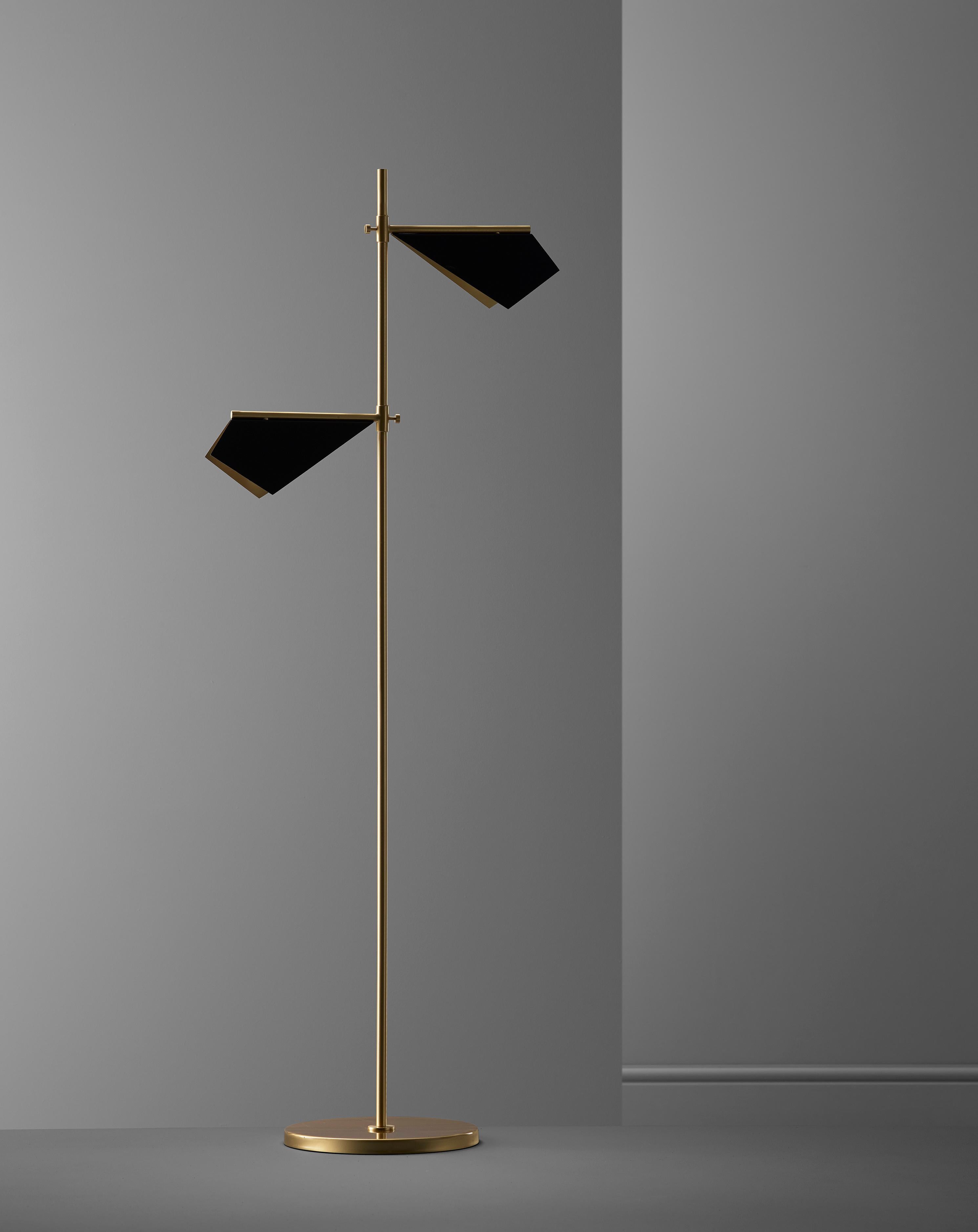 Inspired from observing bats while on vacation, this floor lamp combines a simple folded brass shade along with a long arm brass base and produced entirely from genuine brass. The topside of the shade finished in matt black and the underside in