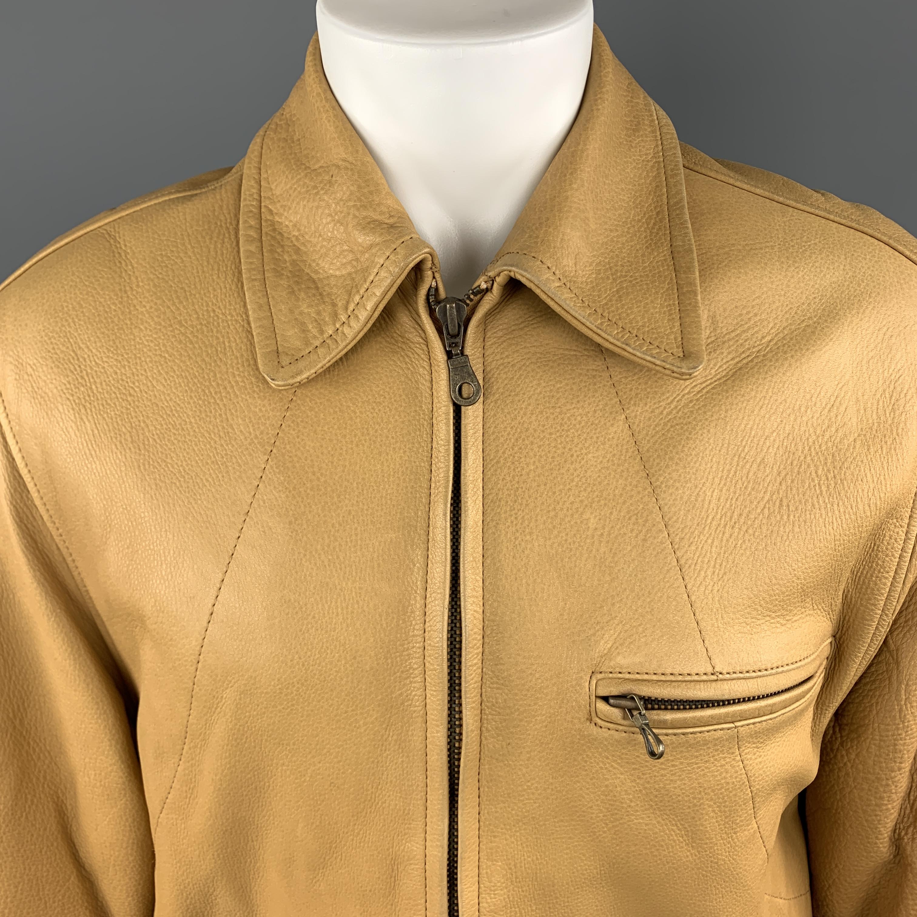 Vintage I. MAGNIN jacket comes in tan khaki textured leather with a pointed collar, zip front, slanted and zip pocket, and side tabs. 

Very Good Pre-Owned Condition.
Marked: S

Measurements:

Shoulder: 18 in.
Bust: 44 in.
Sleeve: 23.5 in.
Length: