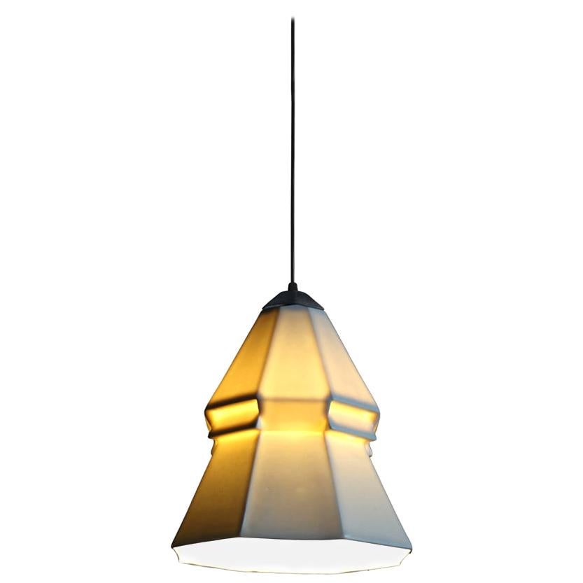 9 inch hanging pendant light from the Expansion collection, this pendant spreads white, direct light downward while the shade emits a soft, warm glow at eye level. It offers a subtle yet striking geometric detail, taking this porcelain design to the
