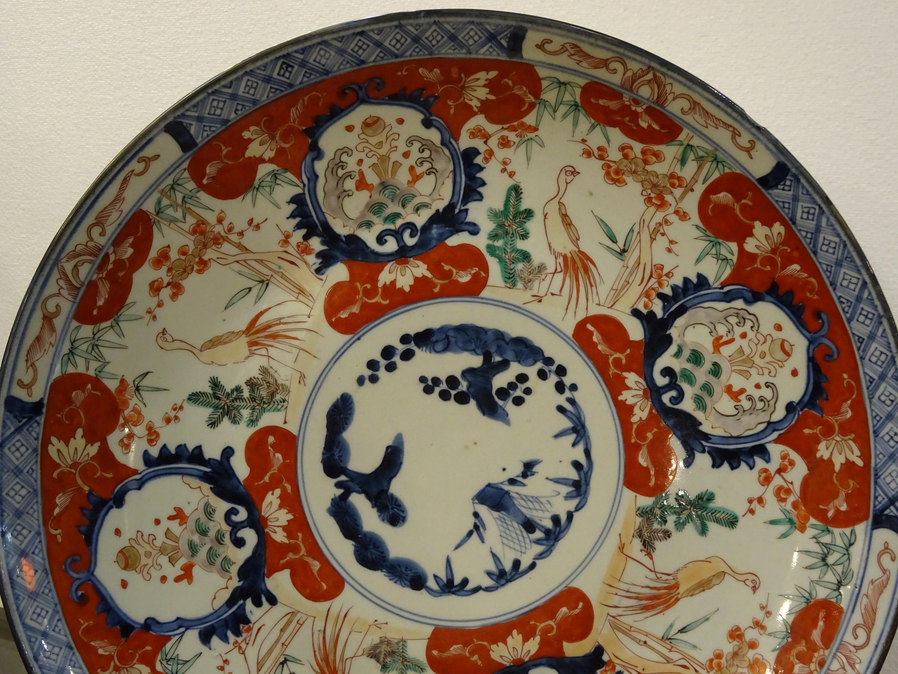 One of a kind large red, blue and white Imari hand painted Japan porcelain plate.
It has the Kakiemon design with flowers in red, blue and green colors and peacocks.
The Imari porcelain was very important in the Edo period, until 1868, influencing
