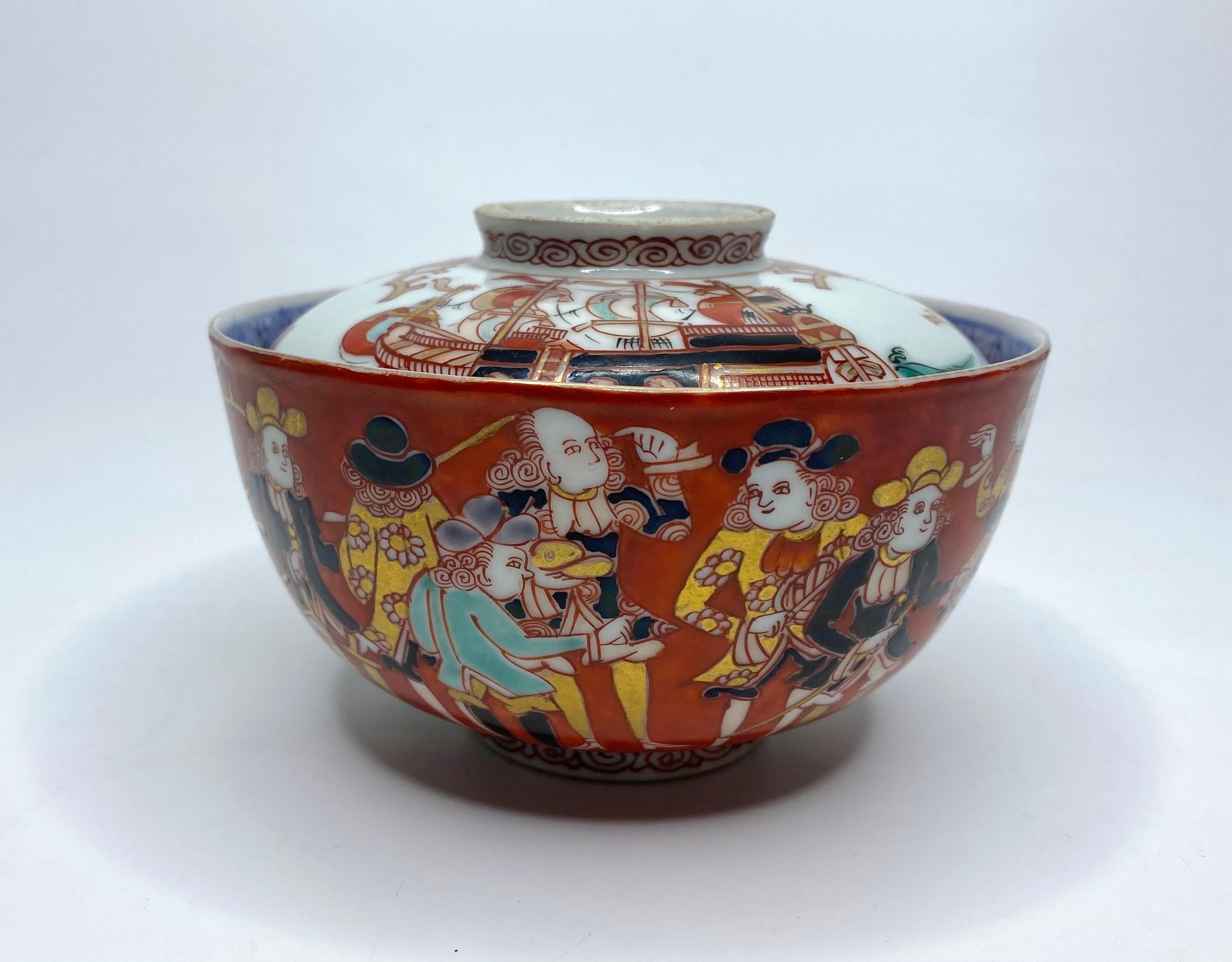 A Japanese Imari porcelain ‘Black Ship’ bowl and cover, Meiji Period. The bowl hand painted to one side with a large sailing ship with Dutch flags, whilst the reverse with a group of Dutch Traders in conversation. Set upon a foot rim painted with a