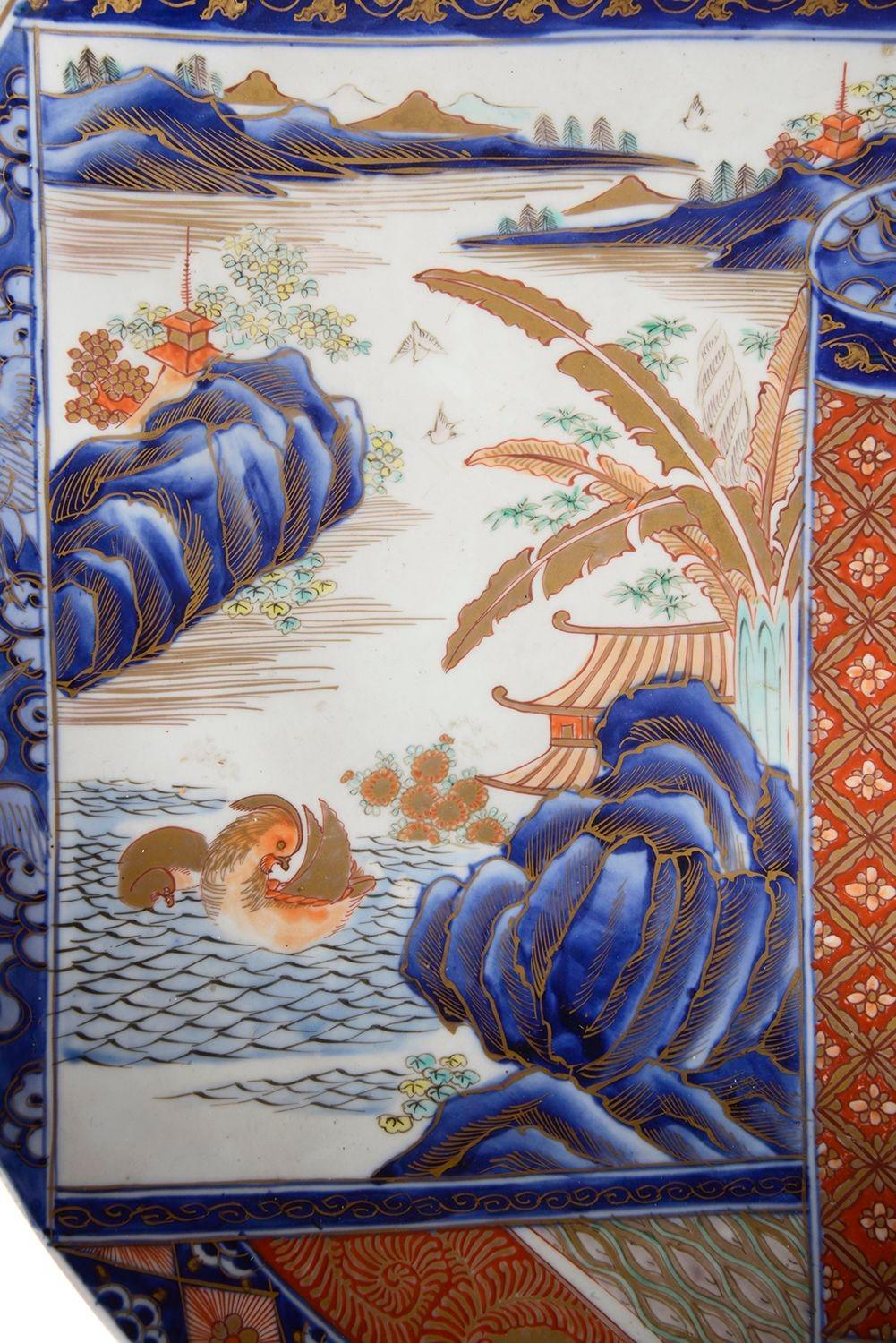 A very good quality late 19th Century Japanese Imari porcelain charger, having classical motif decoration to the boarder, wonderful bold orange and blue colours, a hand painted scene depicting a Japanese scroll with lakes, mountains, pagoda