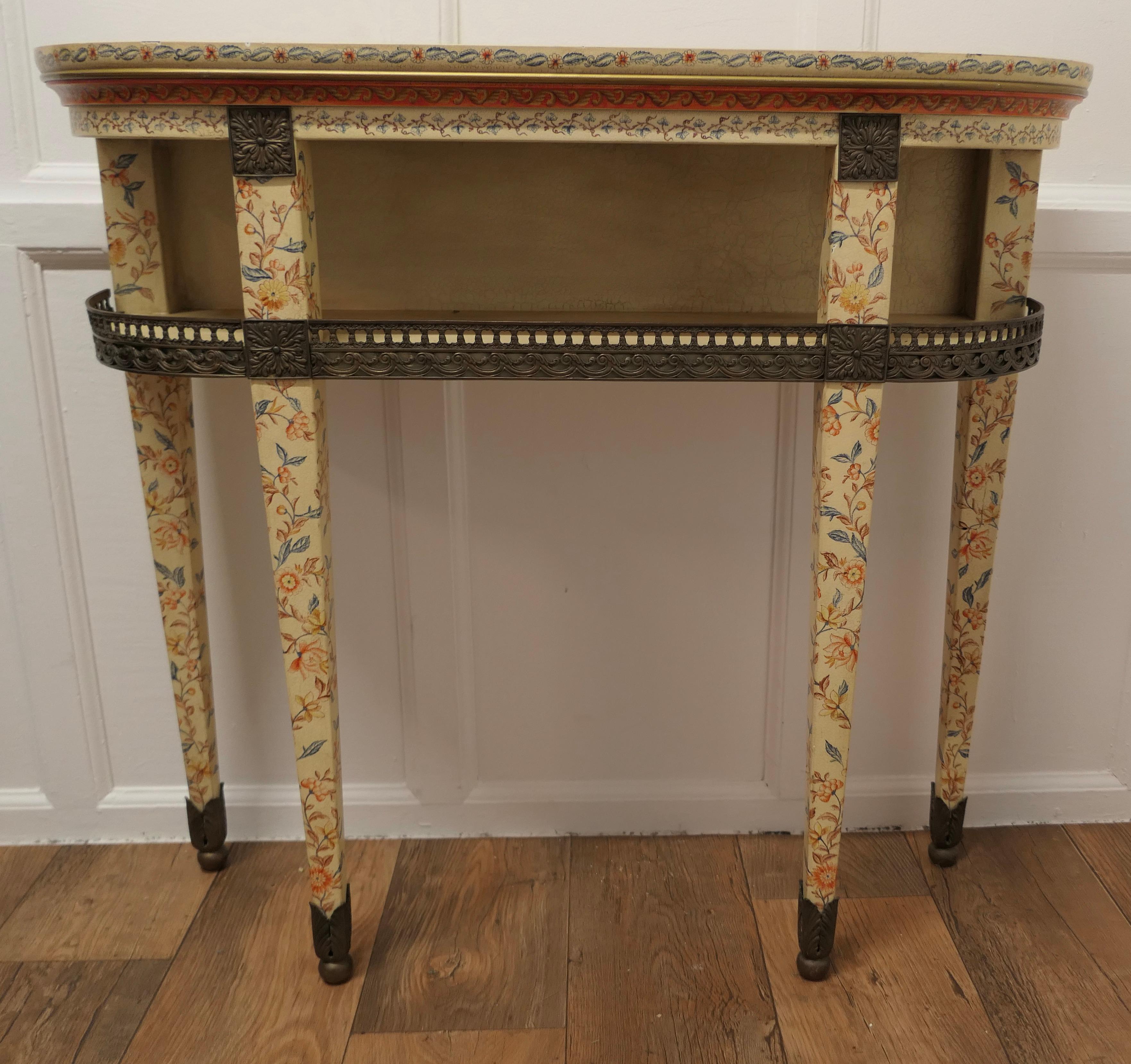 Imari Chinoiserie Style Painted Console Table 

This is a very attractive piece, the table is painted in the Imari Style in blue and coral colours over a crackle undercoat, it has a brass gallery around the undertier with brass detail above and to