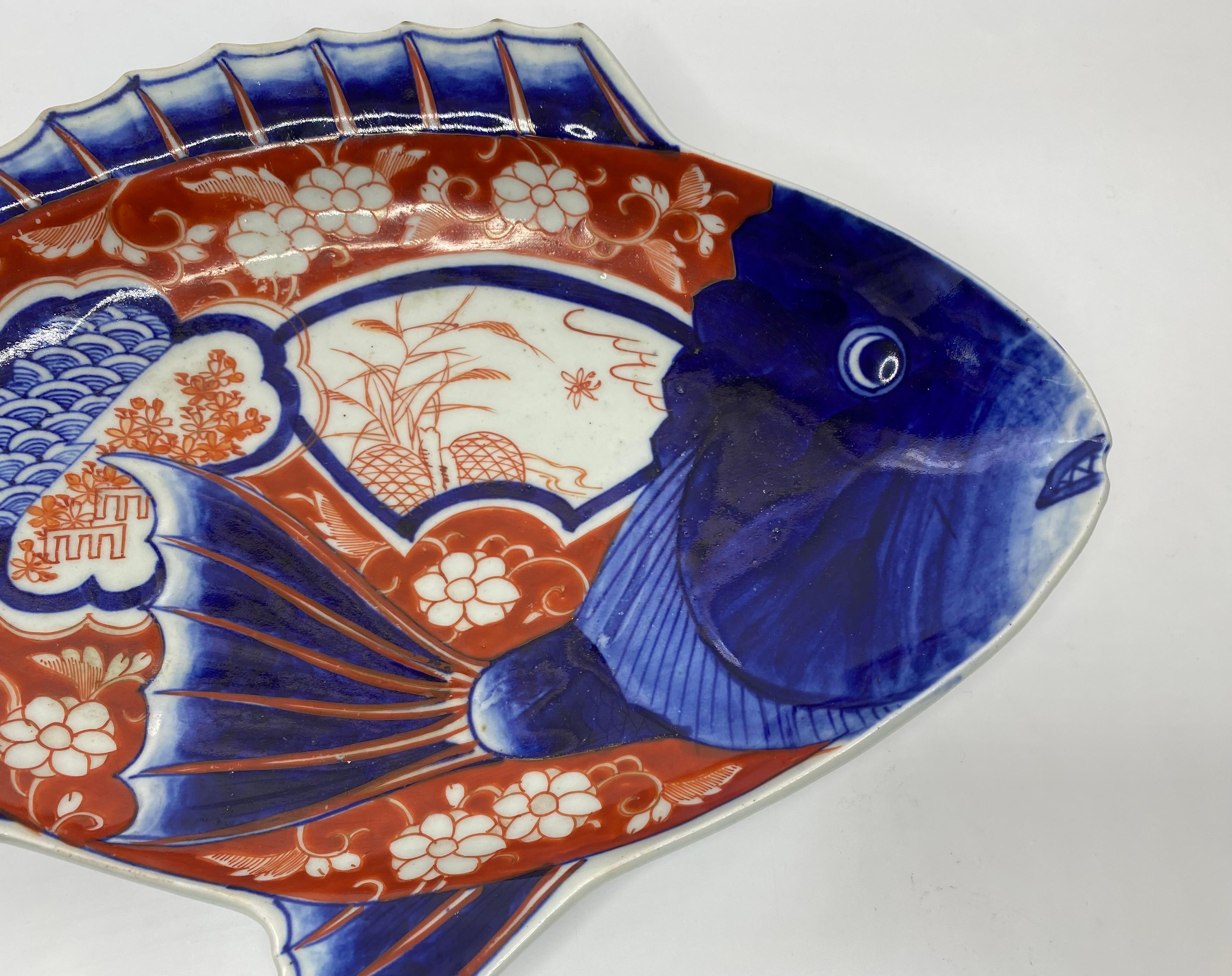Japanese Imari porcelain fish, serving dish, Arita, c. 1890, Meiji Period. The large dish, shaped, in lightly moulded relief, as a carp. Painted with various textile motif, of flowers, plants, and stylised waves.
Length – 36 cm, 14”.
Depth – 24.5