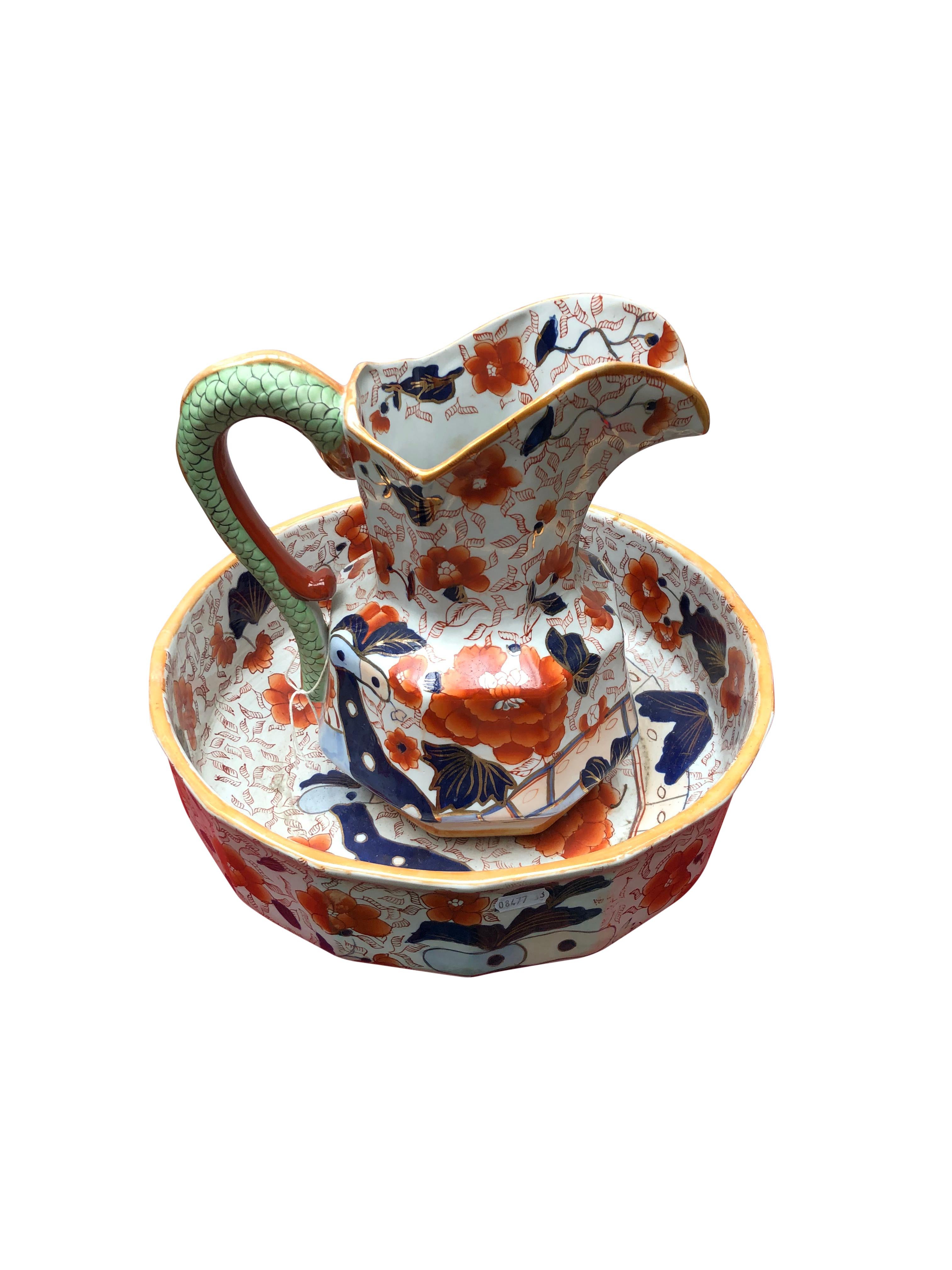 A fantastic Imari jug and bowel, 20th century. The pair is painted in an amazing Japanese style, with bright blue and red floral decorations, and a green scaled handle. Offered in excellent condition, ready for home use right away.