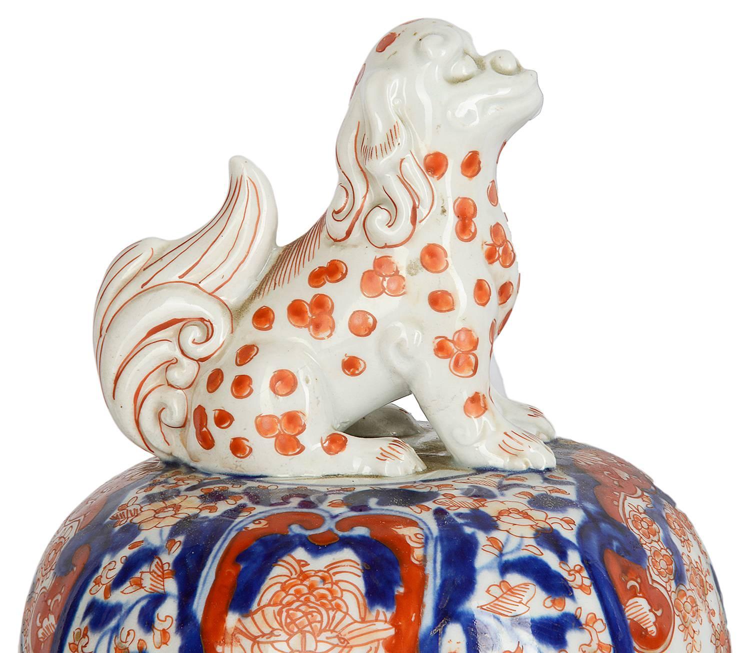 A good quality 19th century Japanese lidded Imari vase, each with dog of faux finial, the classical blue and orange ground having motif, flower and leaf decoration with inset panels of gardens with exotic birds and butterflies.
This vase is very