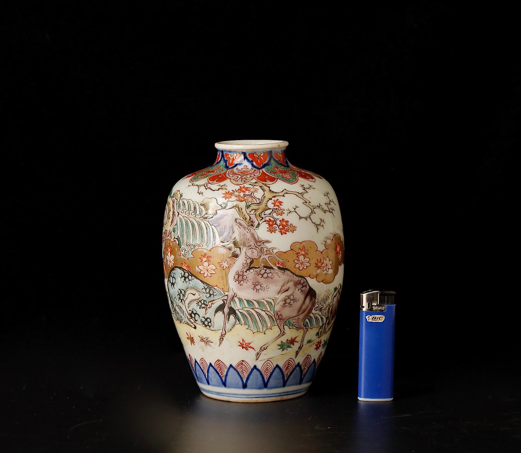 This late 18th to early 19th-century porcelain vase (SKU: ZD47) is an exquisite example of Imari ware, a testament to the rich legacy of Japanese ceramic art. The vase is adorned with a serene pastoral scene featuring deer amidst flora, symbolizing