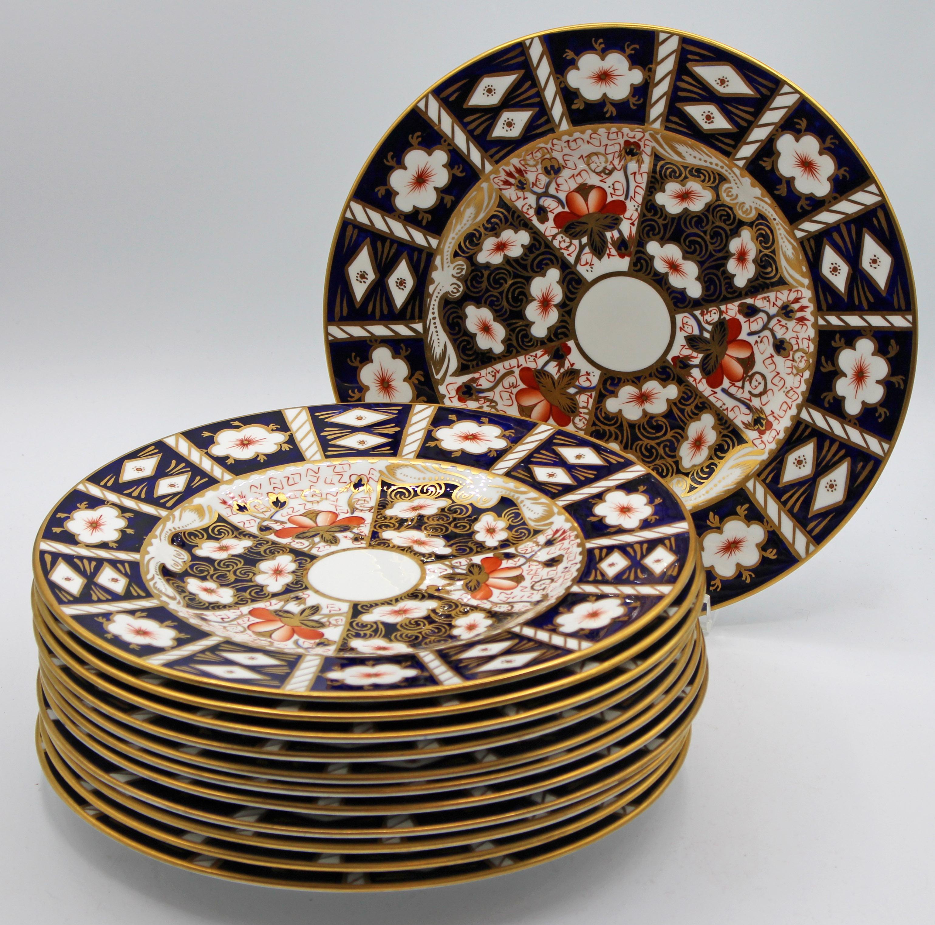 A set of 12 Royal Crown Derby dinner plates, Imari pattern 2451. Post 1976 mark. Hand painted and gilded. Discontinued pattern. 10 5/8