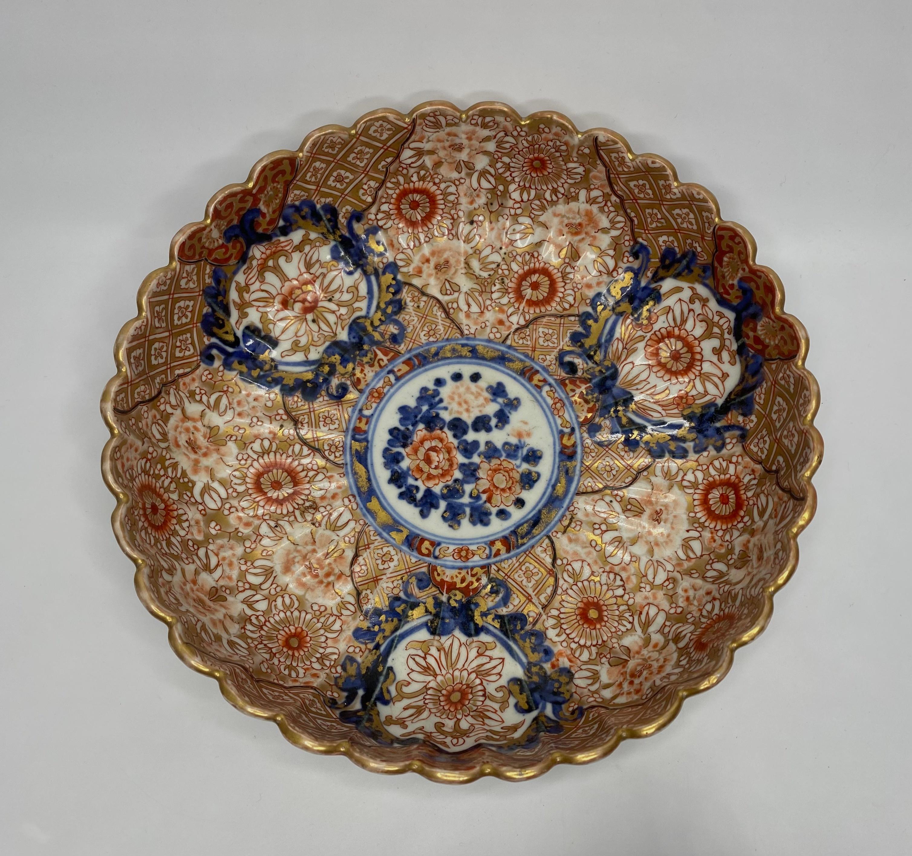 A Japanese Imari bowl, Arita, circa 1890, Meiji Period. The heavily fluted bowl, well decorated in typical Imari style, with panels of stylised flowers, upon a heavily gilded ground of textile motif.
The exterior of the bowl, similarly