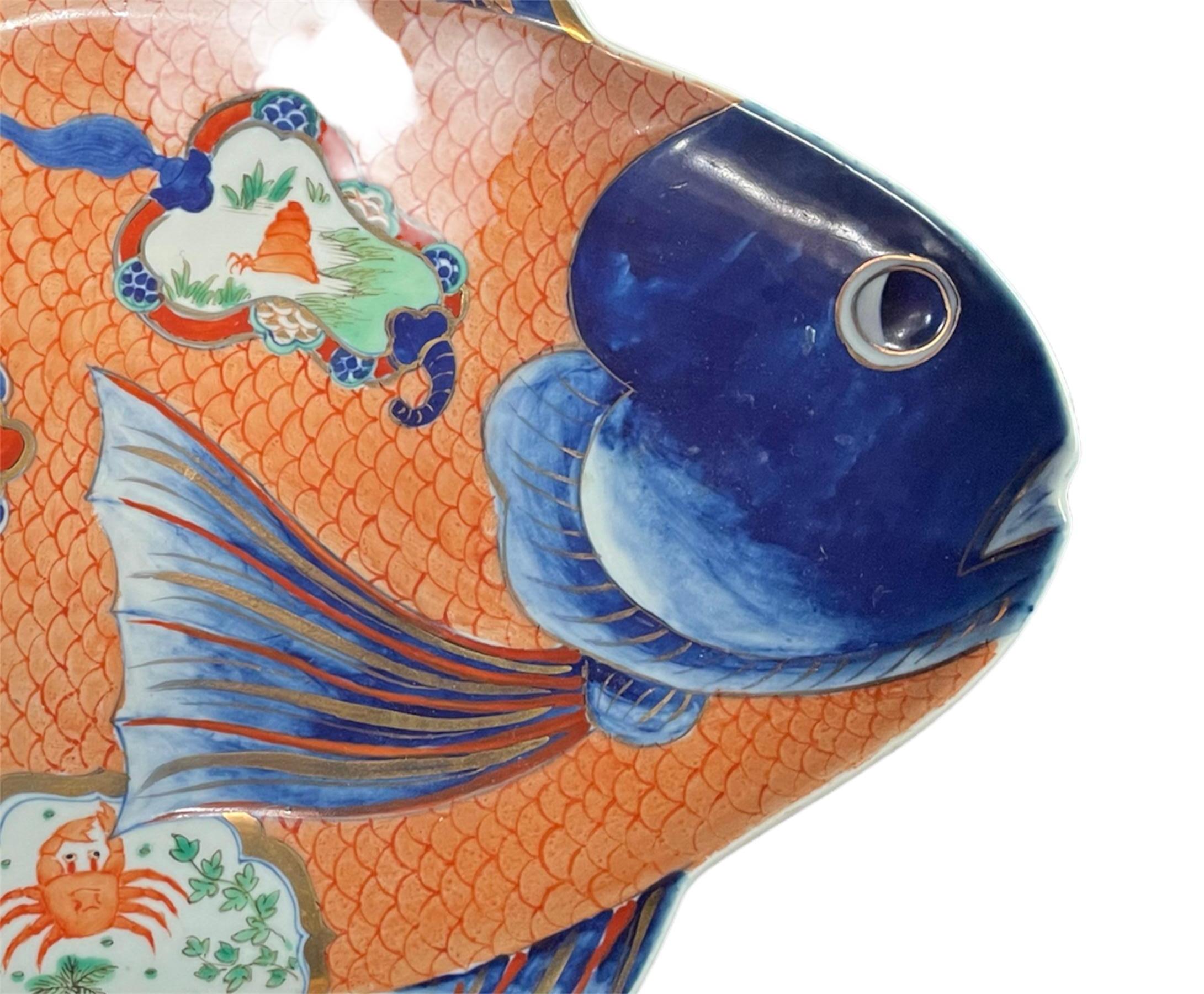 Truly a delicate beauty. A antique porcelain fish platter that can be used in everyday life or for home decor. The beauty of this piece is the hand painted details with a thin glaze, fish in a bowl, the crab is adorable and the gold detail is soft