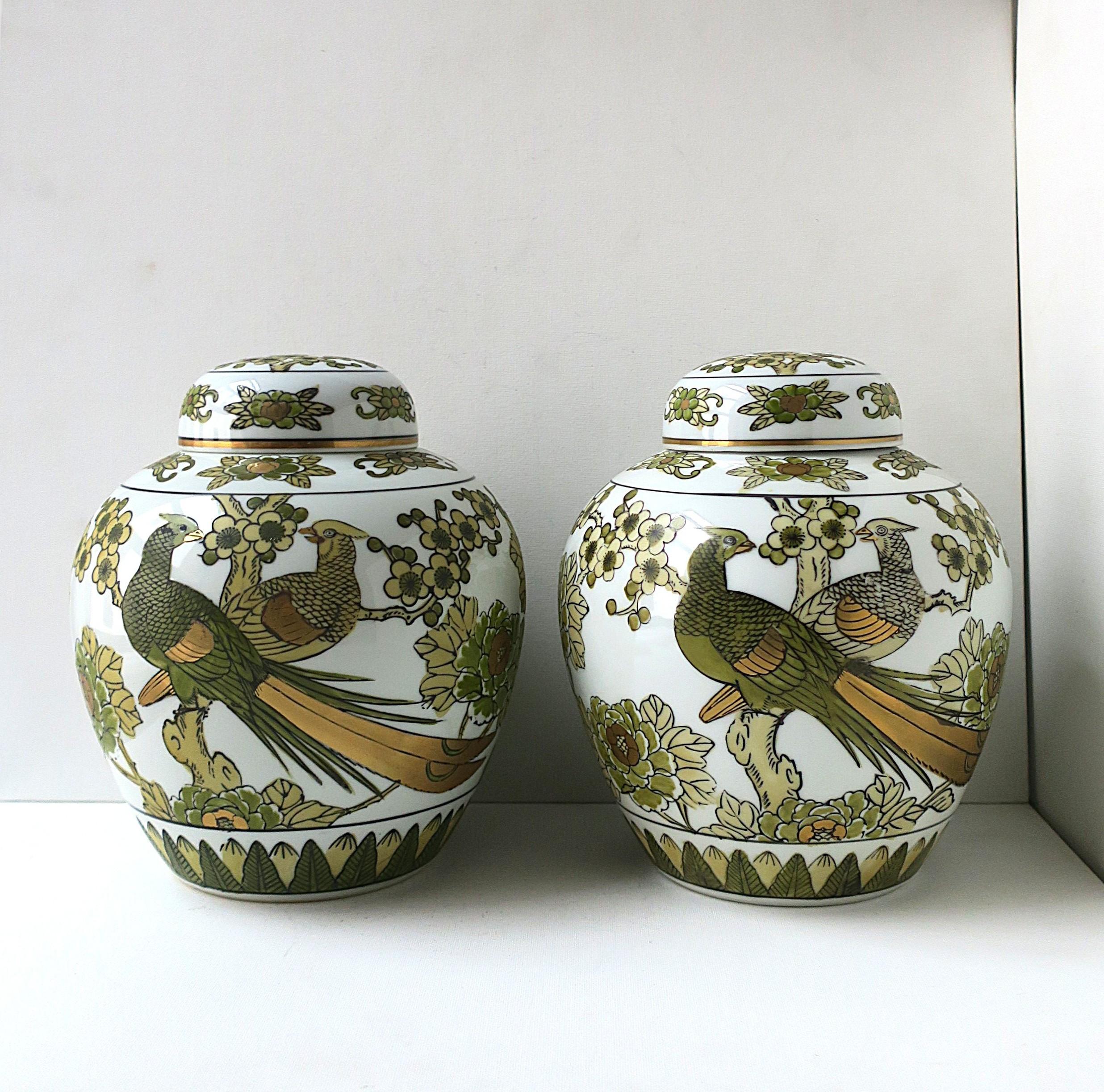 A beautiful collectable pair of ginger jars/vases/urns with pheasant bird design by Imari Porcelain, in the Chinoiserie design style, circa mid-20th century, Japan. Japan is known for its fine porcelain. These 'Gold Imari' lidded porcelain jars are