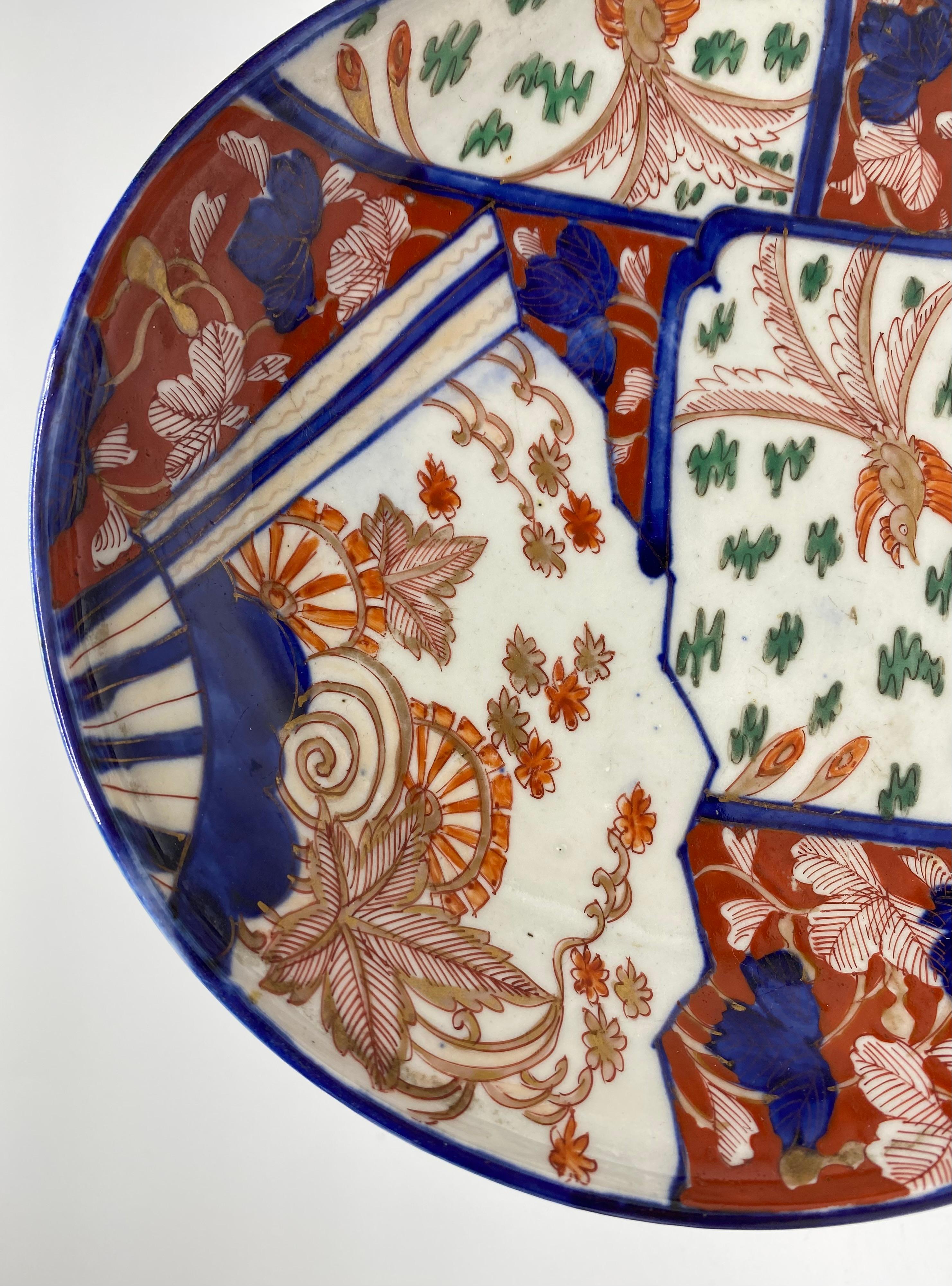Imari porcelain gourd shaped dish, Arita, Japan, c. 1890, Meiji Period. The unusual gourd shaped dish, hand painted in typical Imari colours, with panels of birds flying amongst plants, and a fan shaped panel of plants. All on an iron red ground
