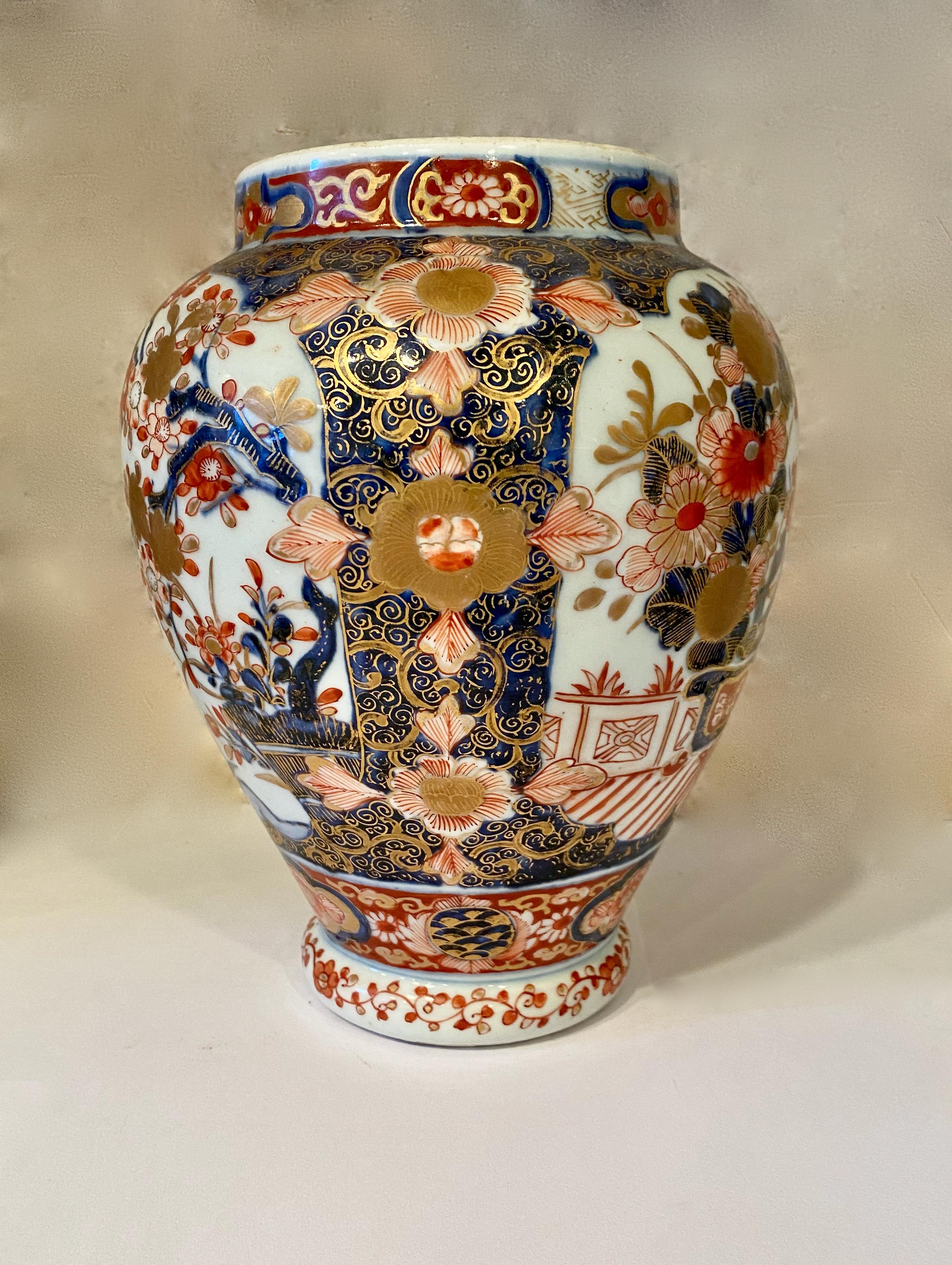 This is a beautifully detailed small Imari vase that is decorated in traditional Japanese elements such as plum blossoms, flower baskets, ho-ho or phoenix birds. The vase is further highlighted in gold leaf. The vase is in overall very good