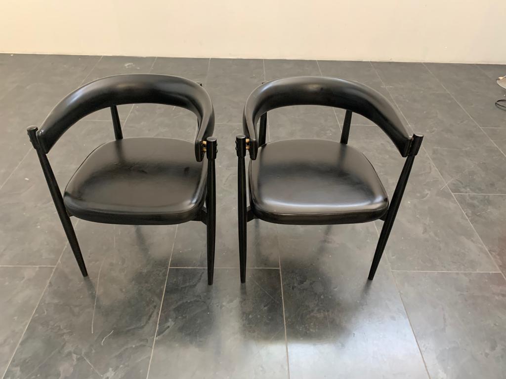 Imitation leather armchairs with brass fittings, set of 2.