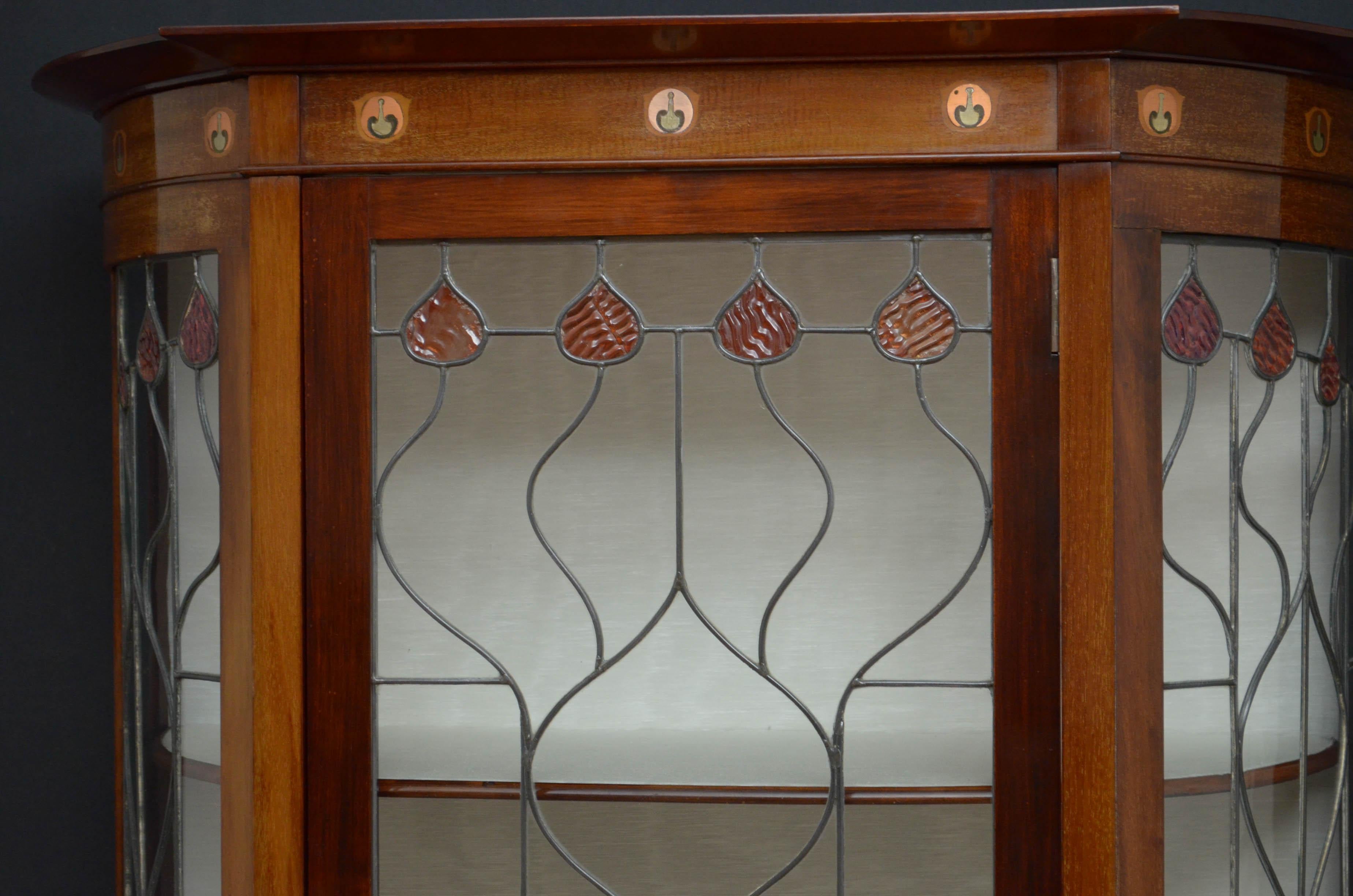Sn4845 exceptional Art Nouveau mahogany display cabinet, having outswept cornice with finely inlaid frieze, leaded glass door enclosing relined interior with 3 shelves and cupboard, all flanked by bowed glazed sides with paneled and inlaid section