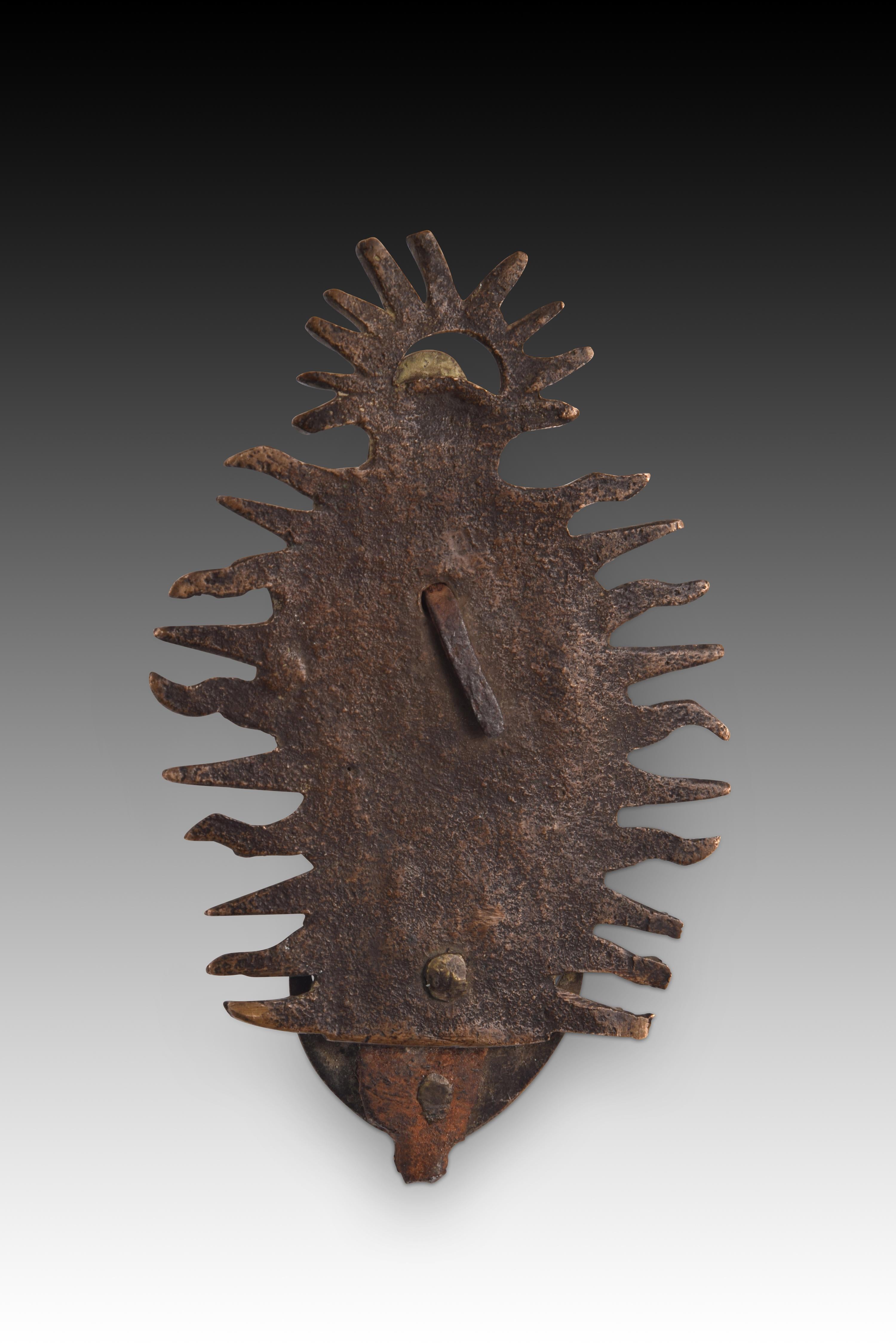 Immaculate. Bronze. Spanish school, 17th century. 
Bronze relief with gilded remains showing an Immaculate Conception. The Virgin Mary stands on a crescent moon with her peaks upward, dressed in a mantle and tunic, joining her hands on her chest in