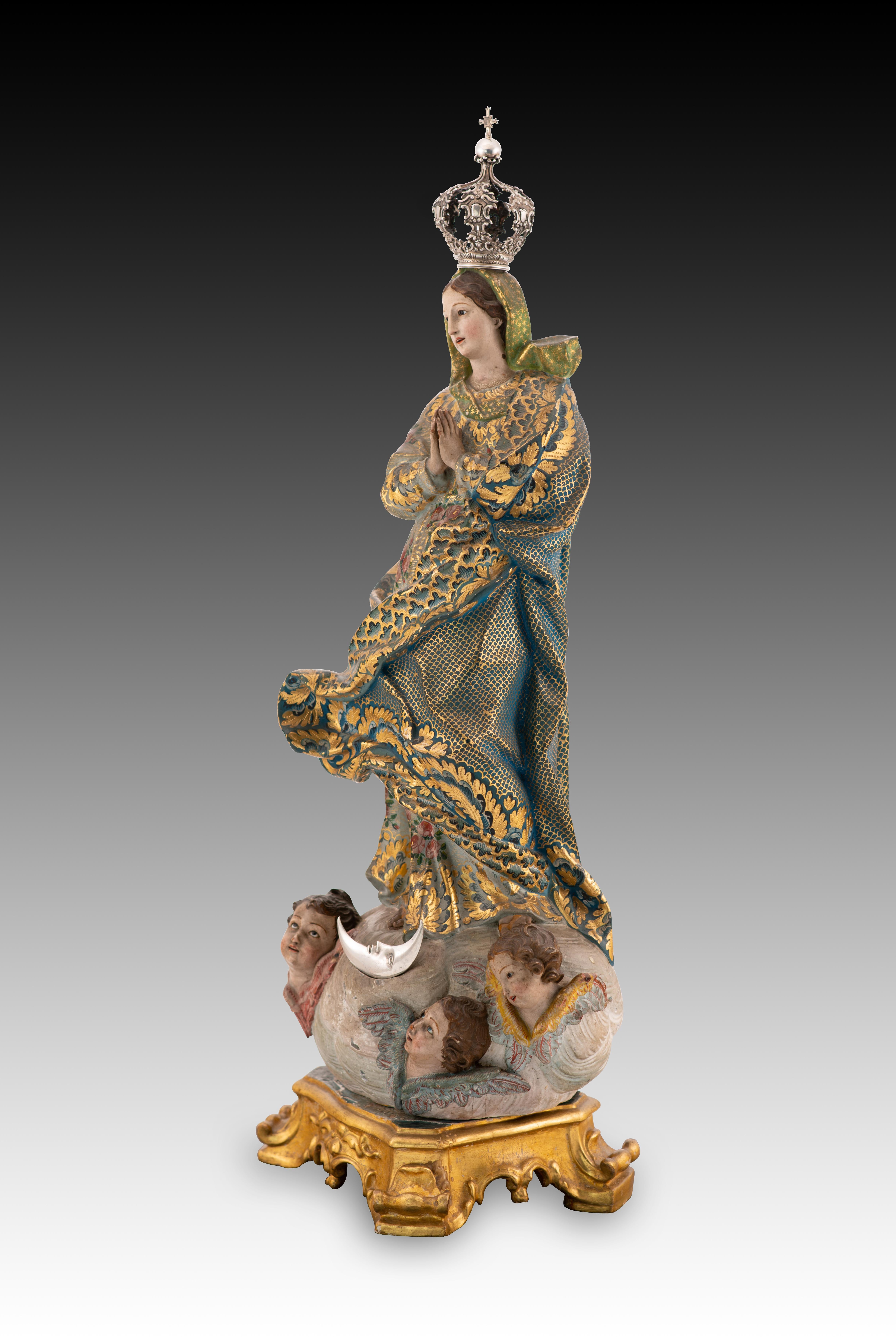 Immaculate Conception. Carved and polychrome wood, glass, silver. Portuguese school, 18th century. 
Sculpture made of wood showing a young Mary, with her hands together in front of her chest in an attitude of prayer, and standing on a cloud, from