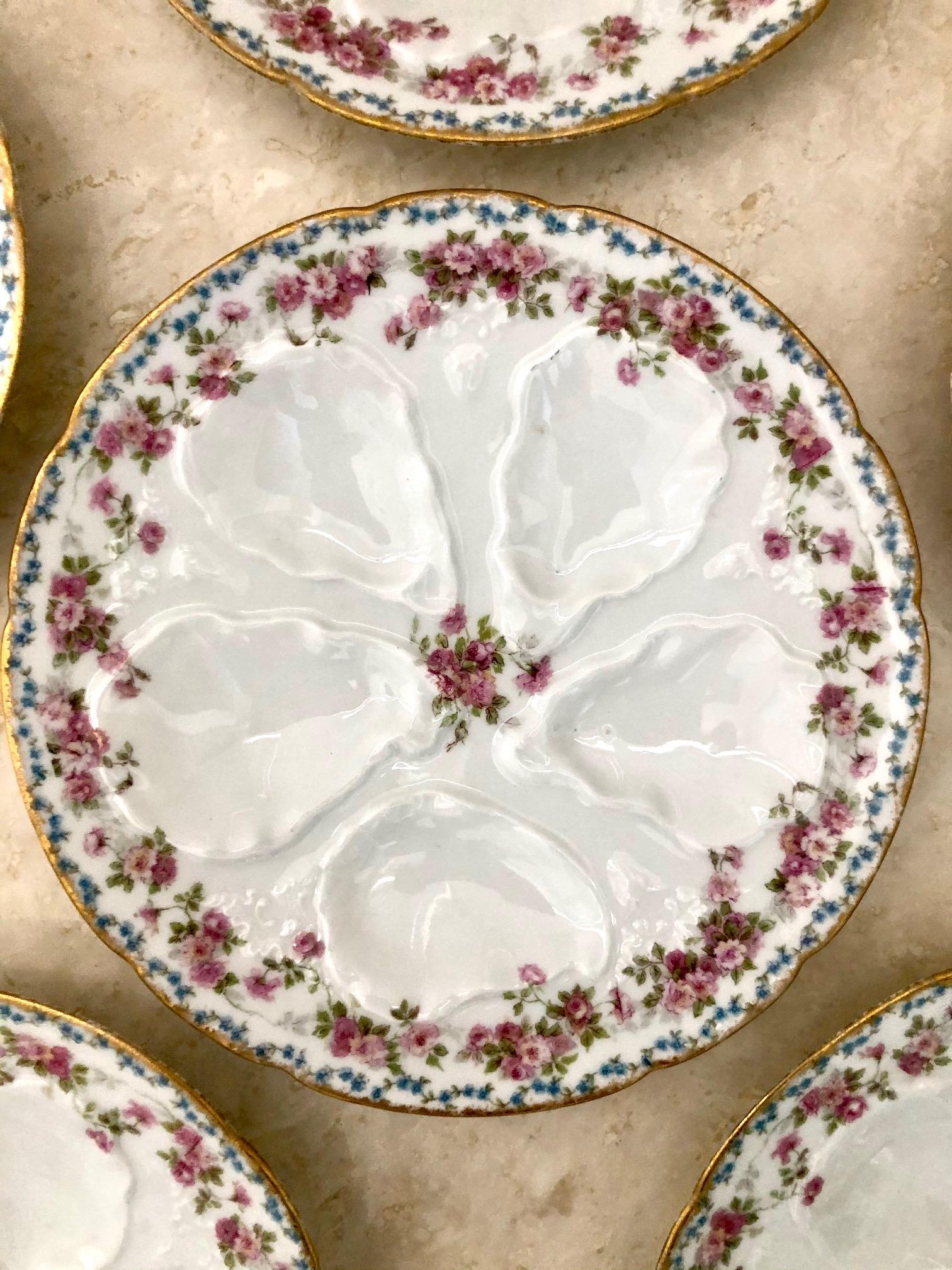 Elegant and Classic, this Limoges oyster plate is contoured for 5 oysters,
and features a charming pattern of pink and purple flowers with a brushed
gold rim. Plate measures about 8 and 5/8