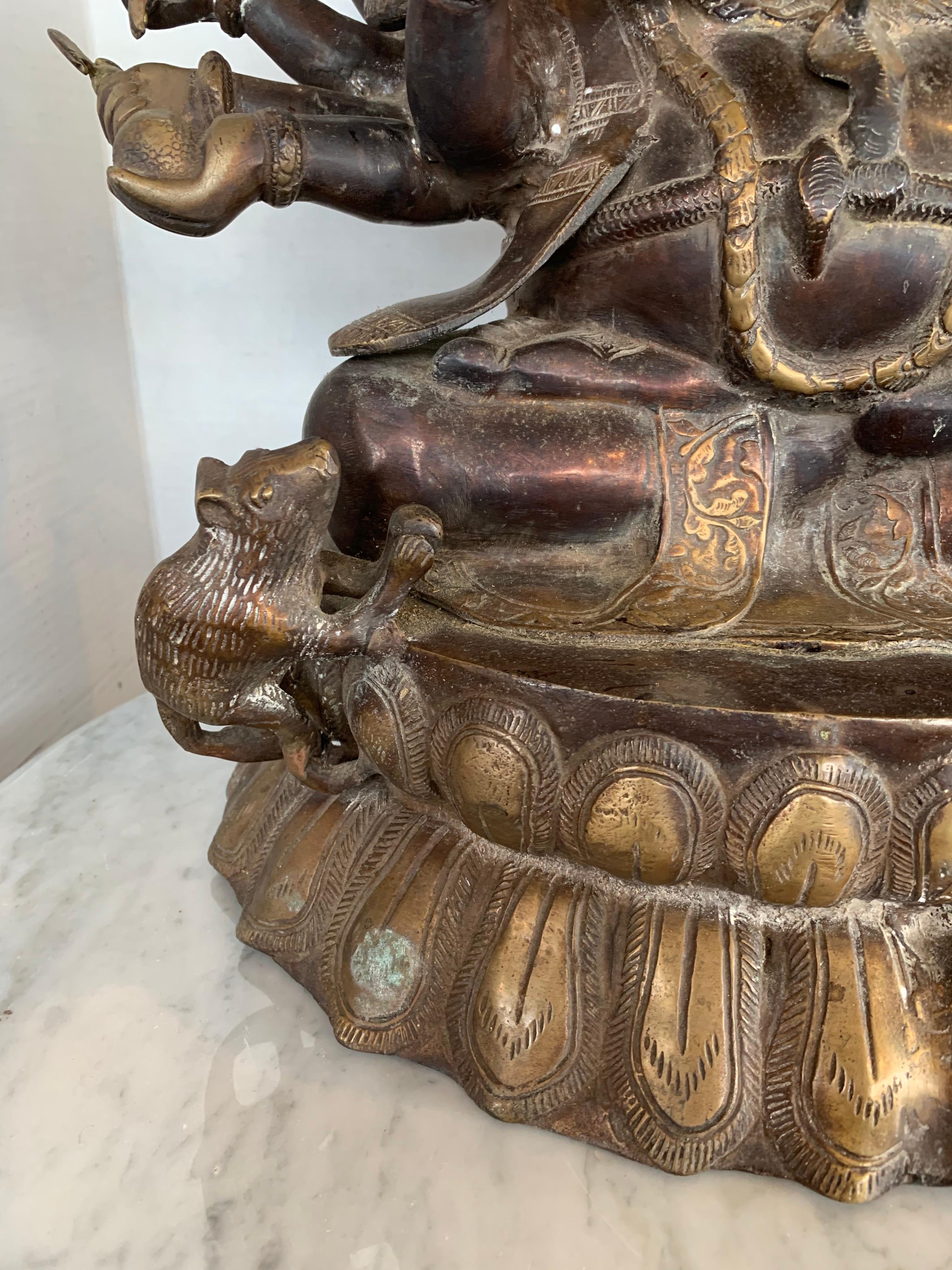 This is a stunning extra large bronze sculpture of Ganesha. This detailed sculpture depicts Ganesha, the Hindu god of success and luck with a rat at his feet. He symbolizes all-pervasiveness. He is elaborately dressed and holding a unique treasure