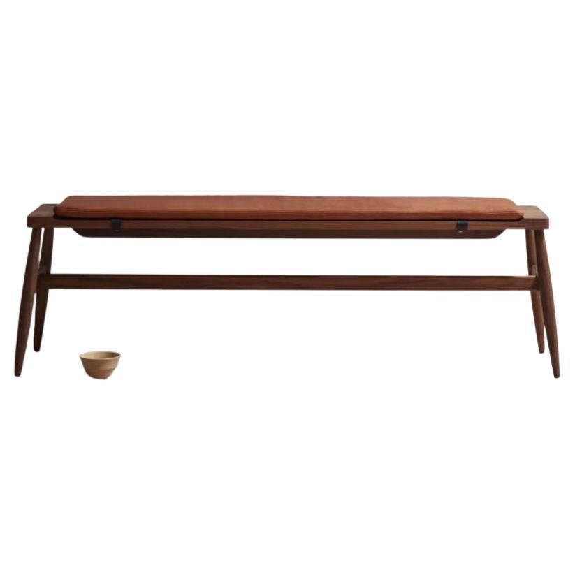 The Imo bench : rigorous simplicity & comfort

The solid timber Imo bench has a sculpted top to accommodate an upholstered pad held in place with leather straps. The pad is available in our house leathers in black or tan.

This contemporary and