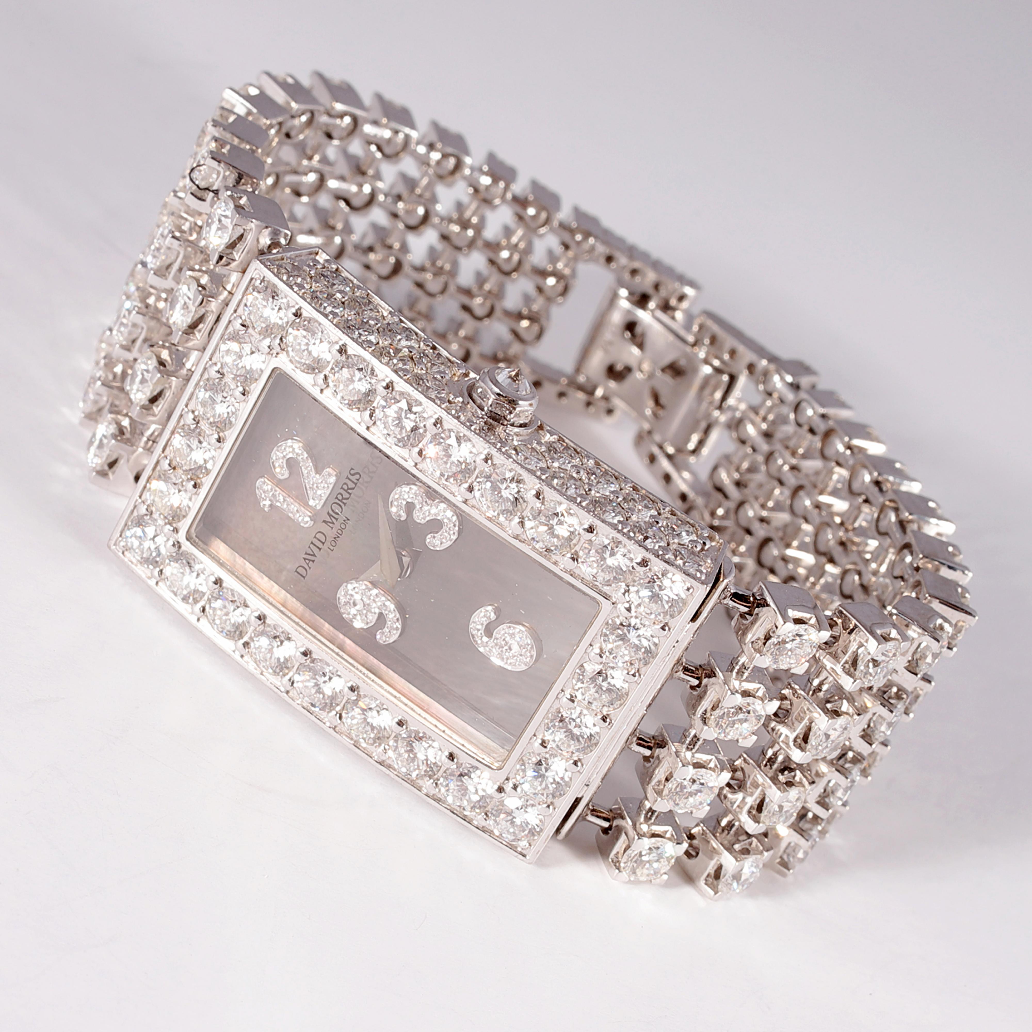 This stunning 18 karat white gold and 20.71 carat diamond watch is absolutely gorgeous!  By famed London designer, David Morris, these diamonds are beautifully matched with D - E - F in color grades and approximately VS in clarity. The gray
