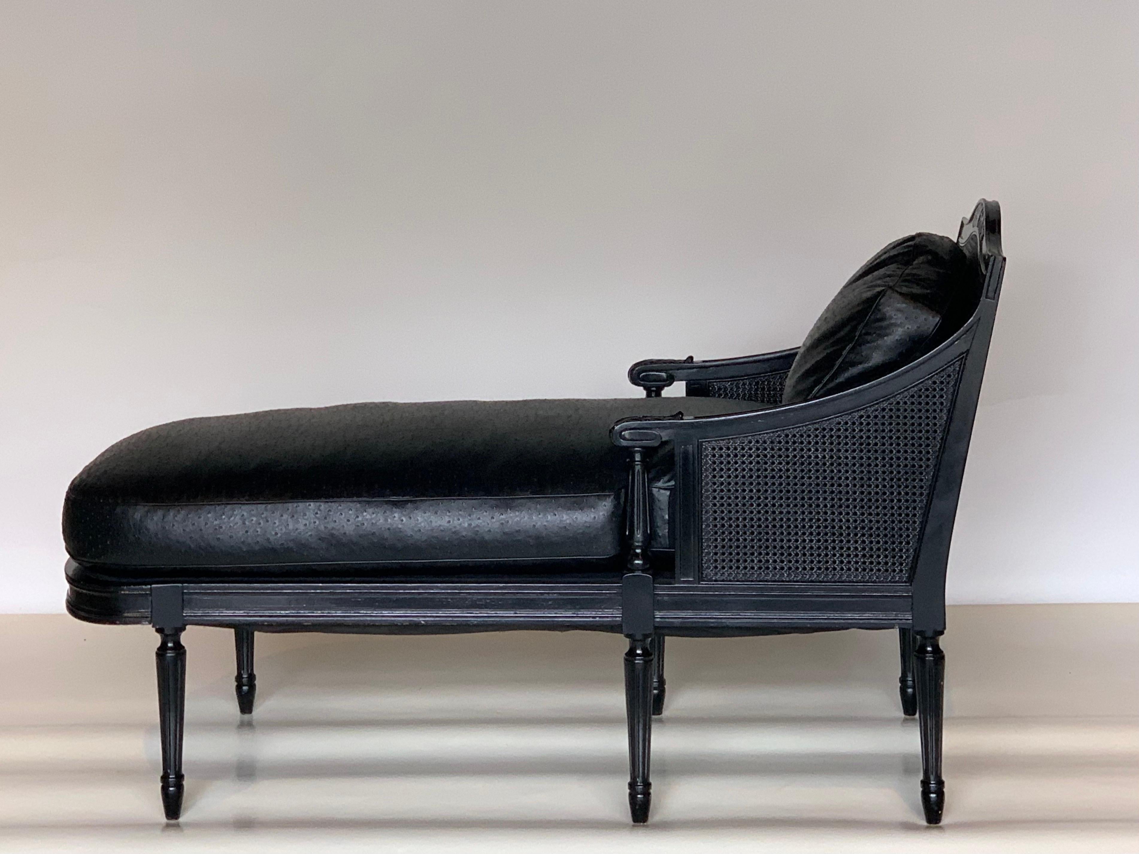Impeccable French Louis XVI style black leather chaise longue or daybed. In the style of Maison Jansen.

Sturdy lacquered caned hardwood frame with ostrich pattern black emu leather upholstery.