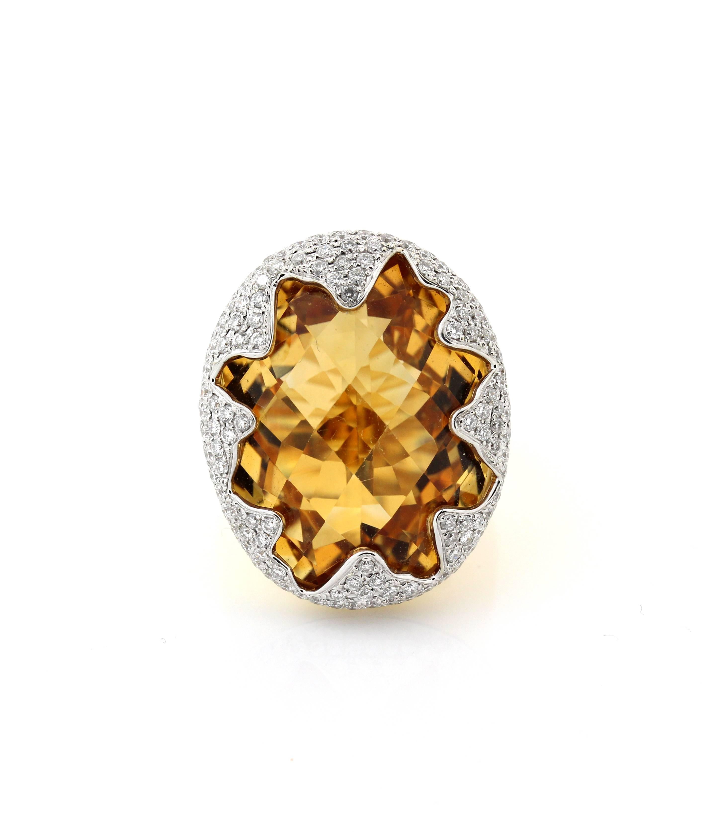 18K Yellow and White Gold Ring with Imperial Citrine Center and Diamonds

Center Citrine is gorgeous in color, has a slight color change aspect. The carat weight is unknown but we are estimating around 20 carat's. The face of the ring is 1.1 inch x