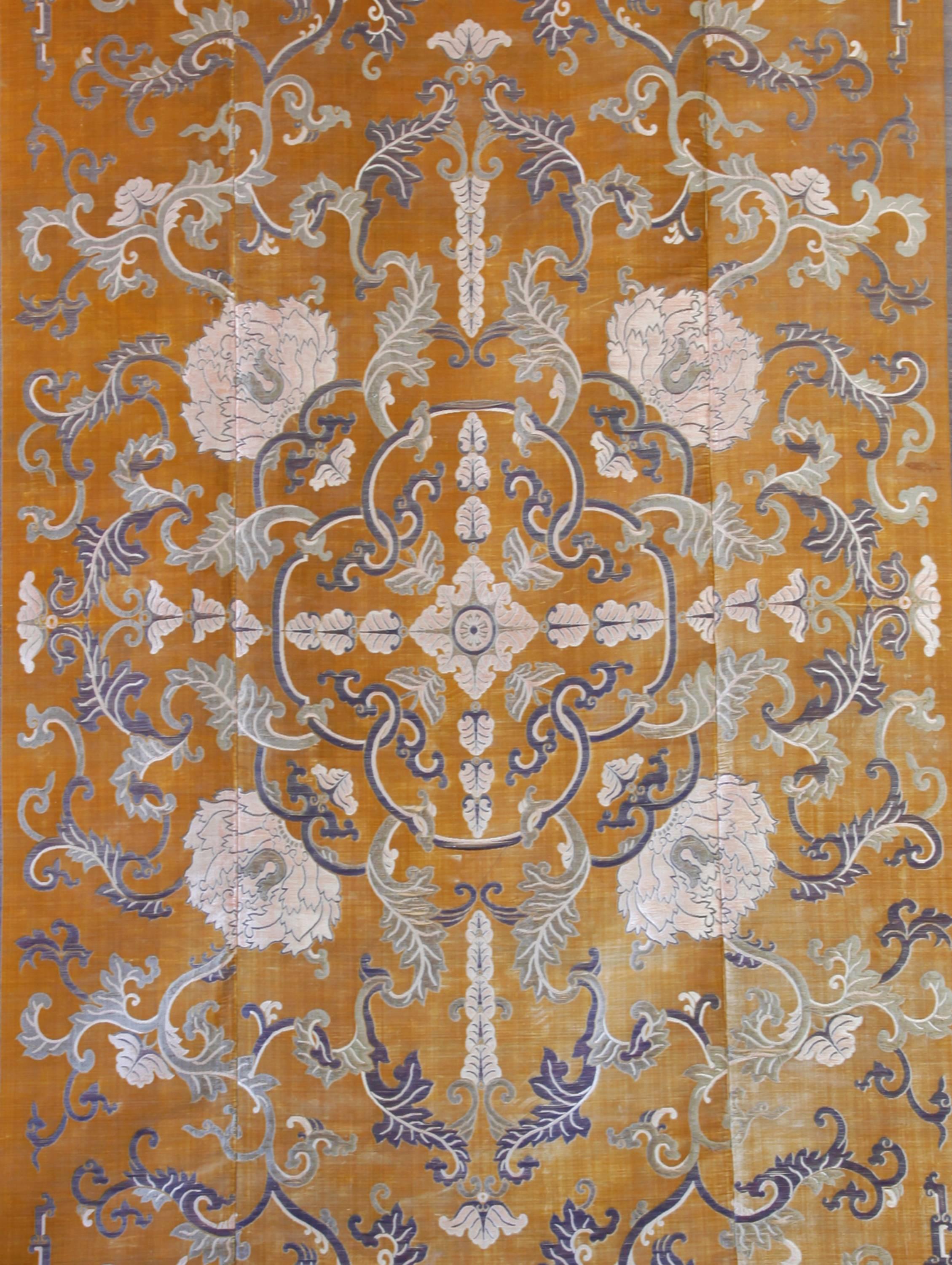 A large and rare imperial cut silk velvet and metal-thread Kang carpet
Qing dynasty, Yongzheng period

This magnificent carpet is composed of three joined panels of rich amber-colored cut and uncut silk velvet with a central medallion surrounded