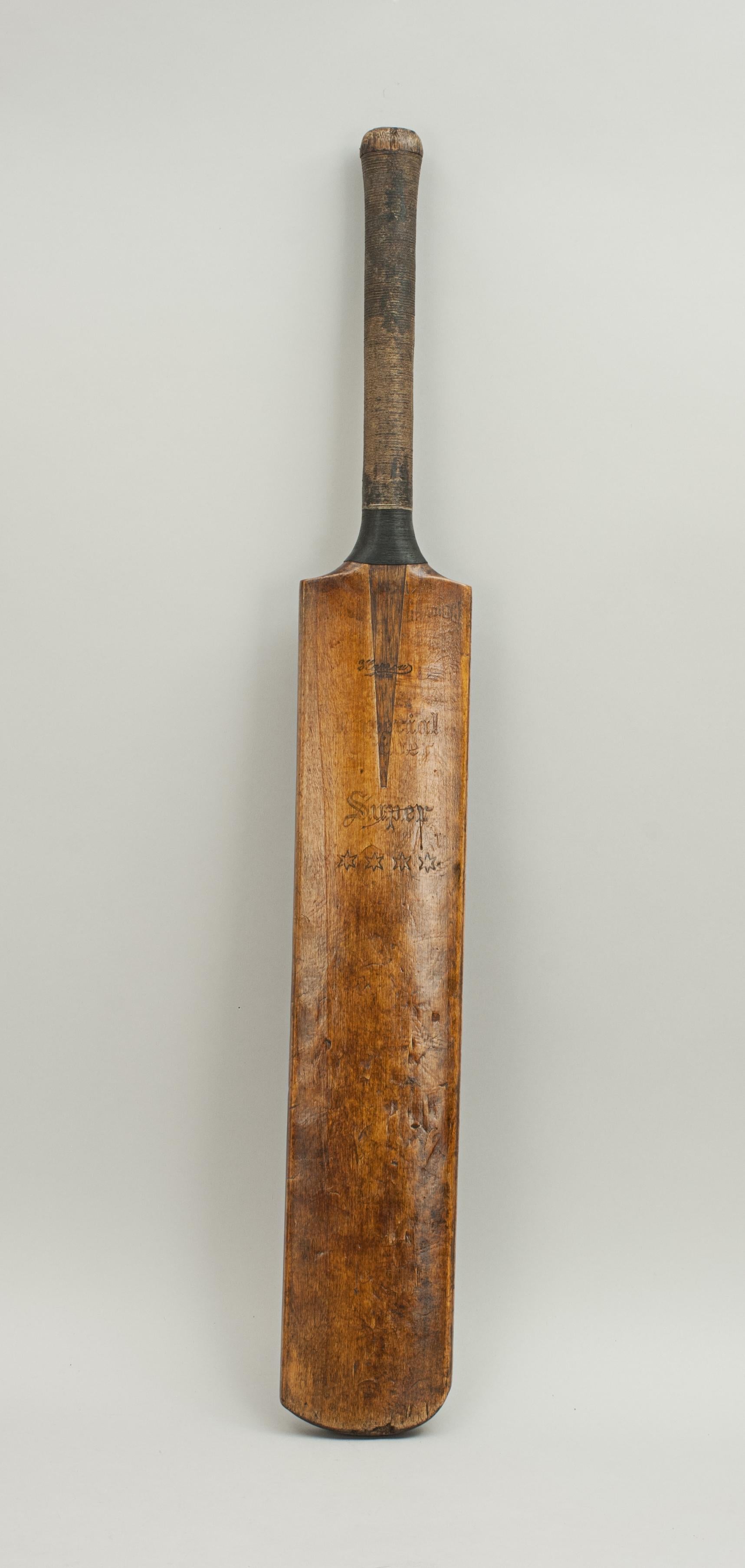 Antique Gradidge cricket bat.
A good willow cricket bat by Gradidge of London. The 'Imperial Driver' is in good condition with nice patina. The blade is embossed 'Gradidge, Imperial Driver, Harrow, Super & 4 stars', the handle with strung grip.
 
