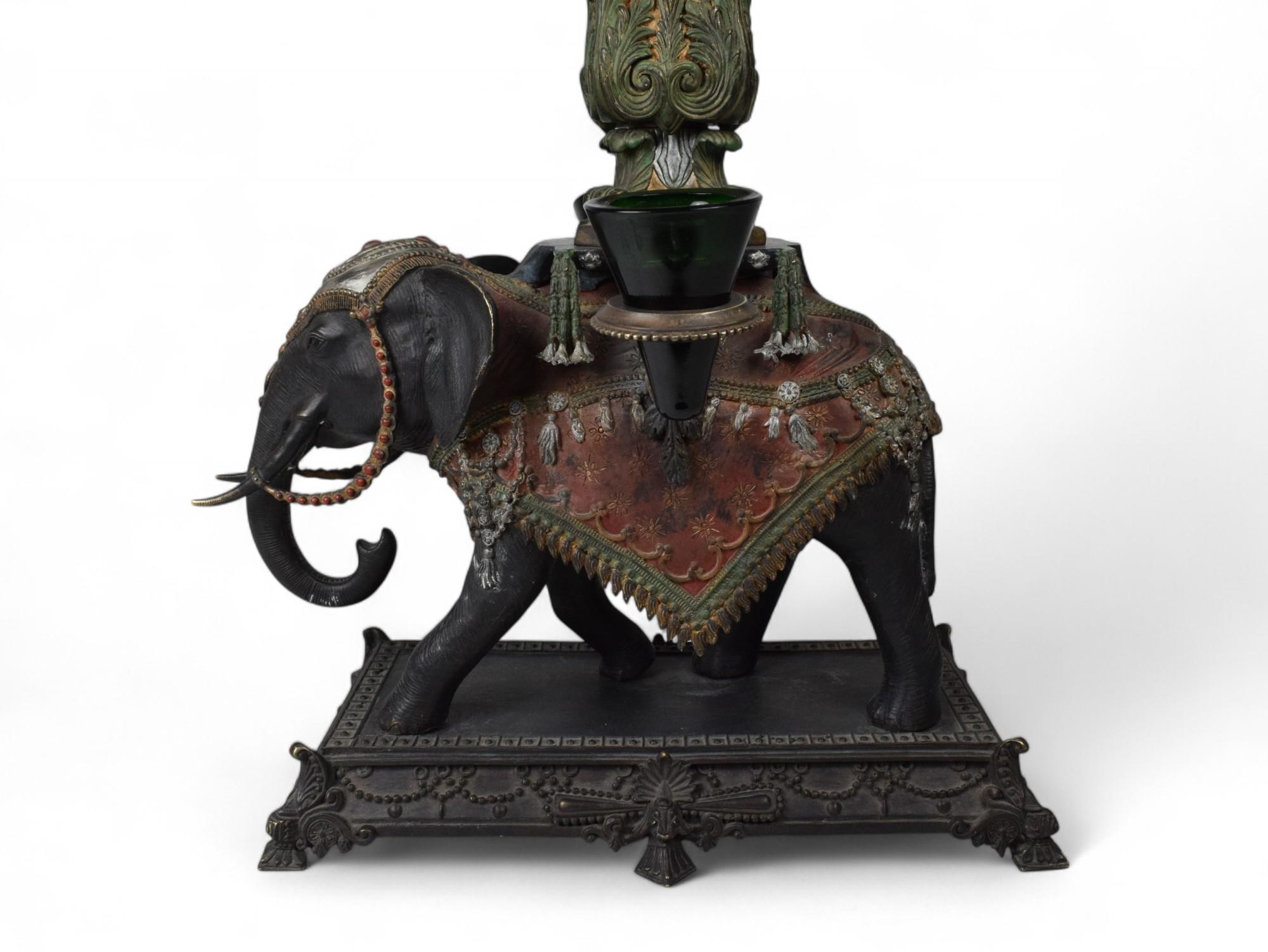 Imperial Elephant Candelabrum
Europe, Early 20th Century
Height: 34 in.  Width: 17 in.  Depth: 15 in.
Materials: Patinated Bronze, Semi-Precious Stone, Colored Glass
Provenance: Private European Collection

Step into a world of regal fantasy with