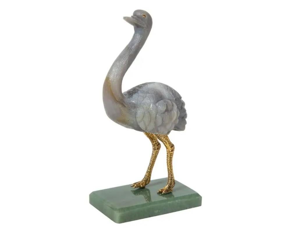 An imperial Faberge carved Labradorite ostrich on nephrite base, 20th century 
In original box. Limited Edition: 18/250 
Measures: 7″ high x 3.5″ deep x 2″ wide 
Very good condition. No damages noted.