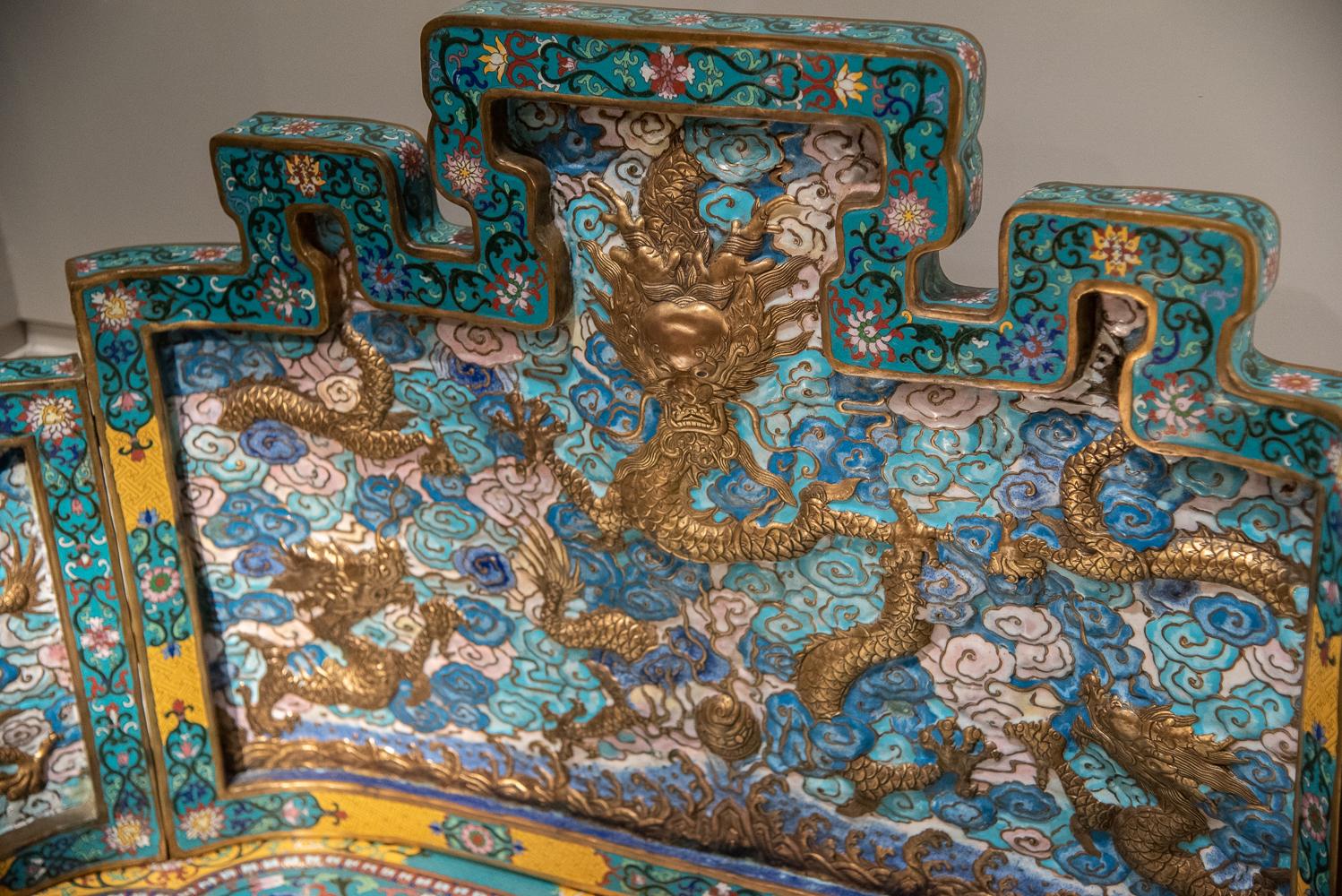 Rare imperial gilt copper and cloisonné enameled throne and footrest of extraordinary design and execution.

Of rounded rectangle conformation, the back shaped to represent the five (5) sacred mountains. The recess-paneled sides, back, and apron