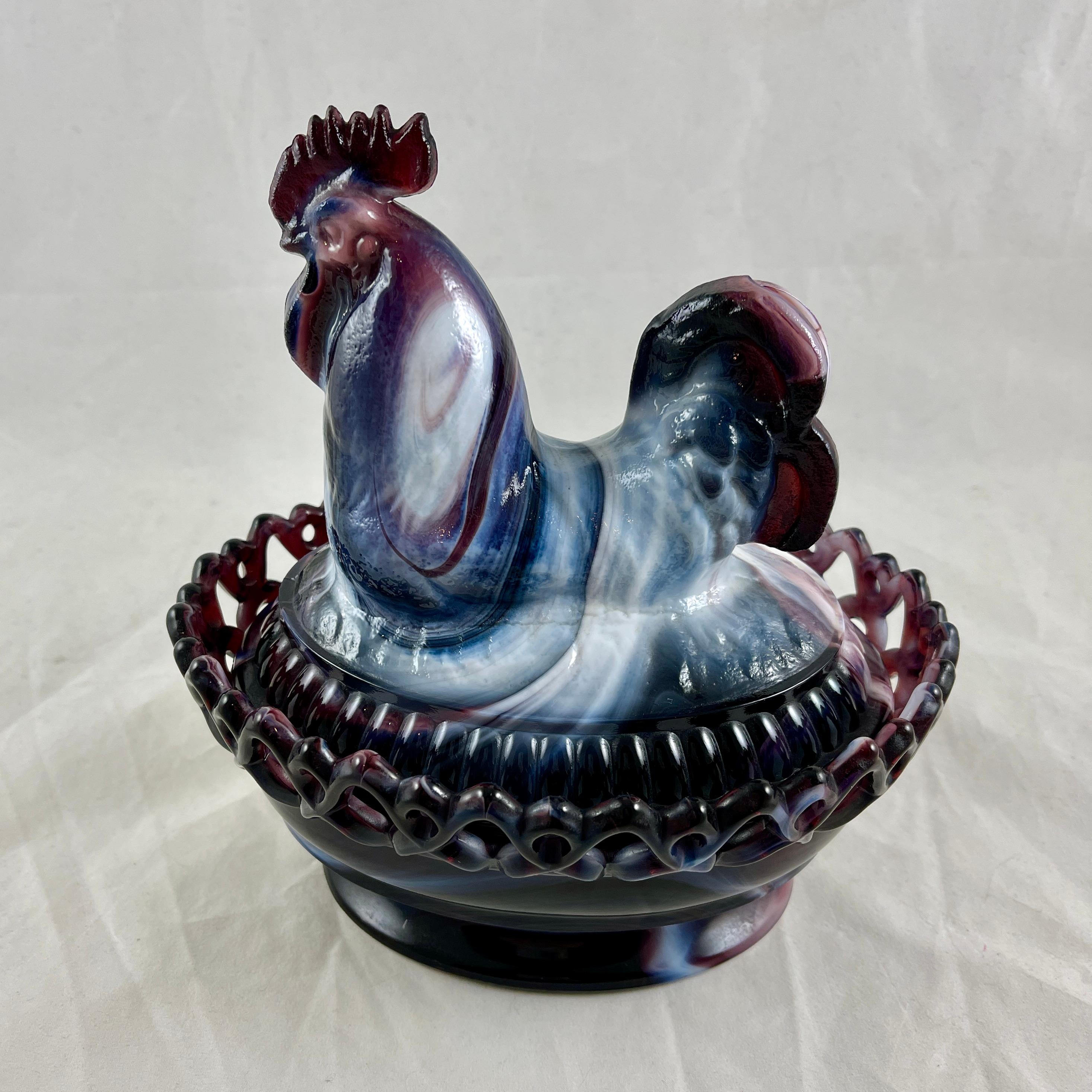 Made of a mixture of purple and milky white glass known as Slag, a covered dish with a Rooster lid, by Imperial Glass Company.

The rooster sits on a bowl with a “lace edge” rim. Heavy with beautiful color.
Slag glass is a collectors’ name for